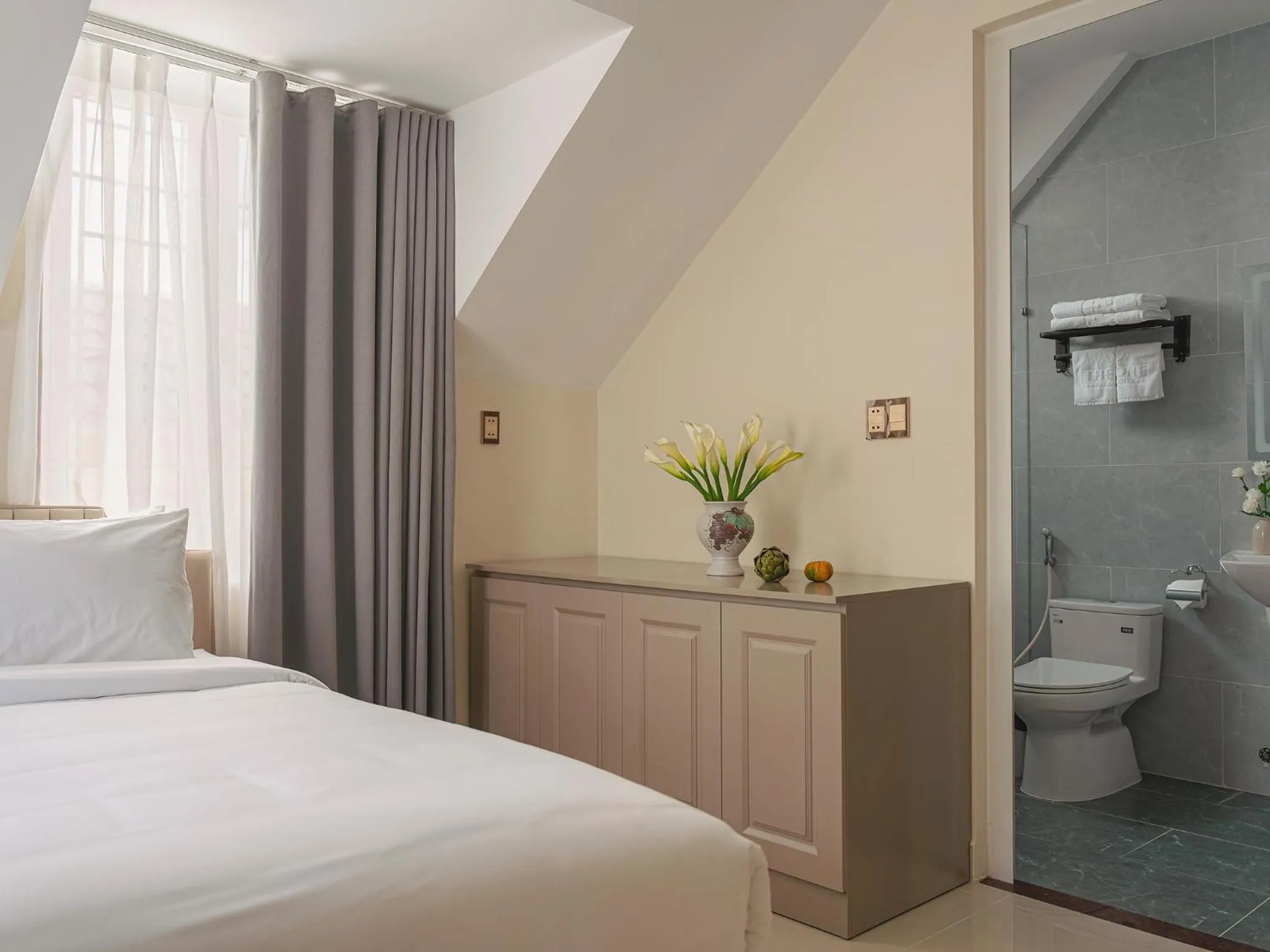 Toilet, Bed in The One Da Lat Hotel