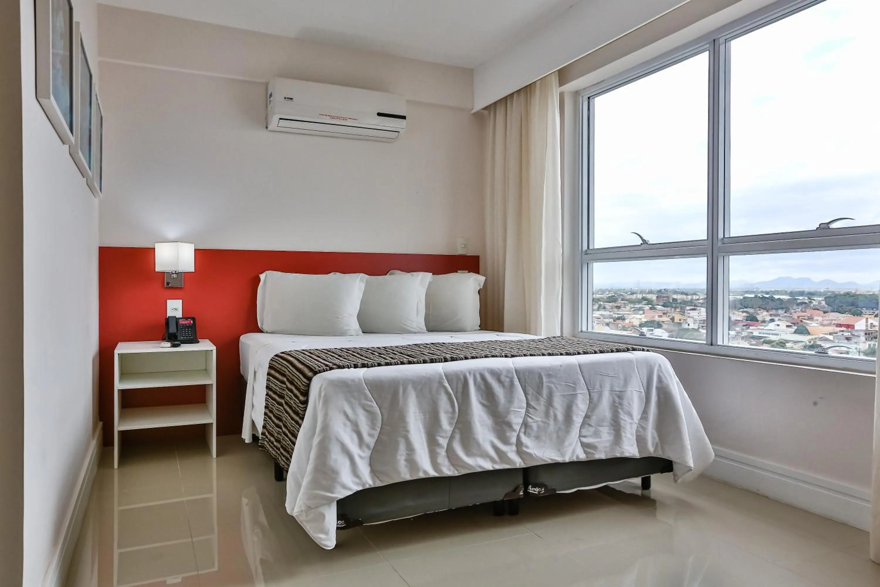 Bed in Ramada Hotel & Suites Campos Pelinca