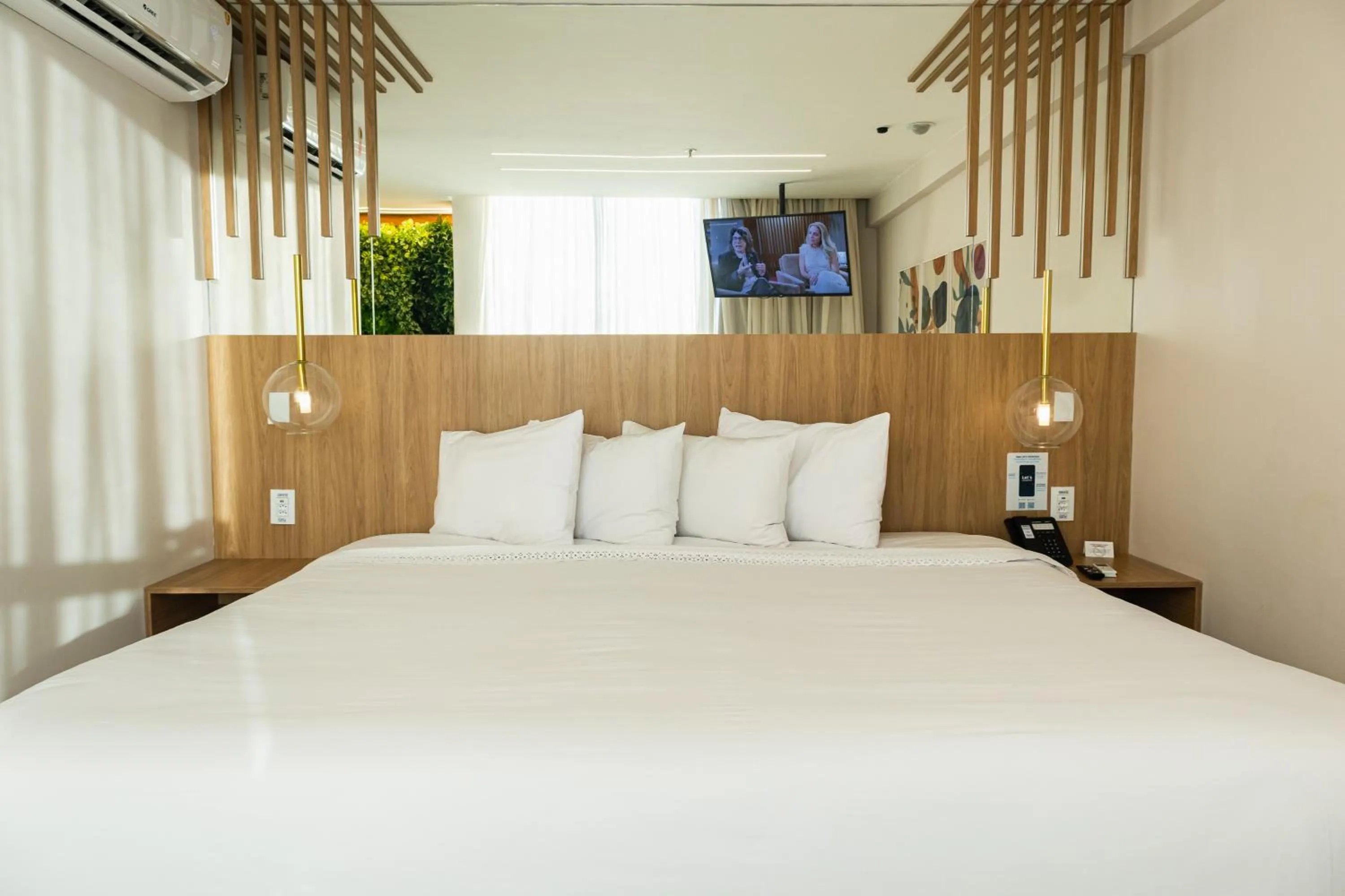Bed in Ramada Hotel & Suites Campos Pelinca