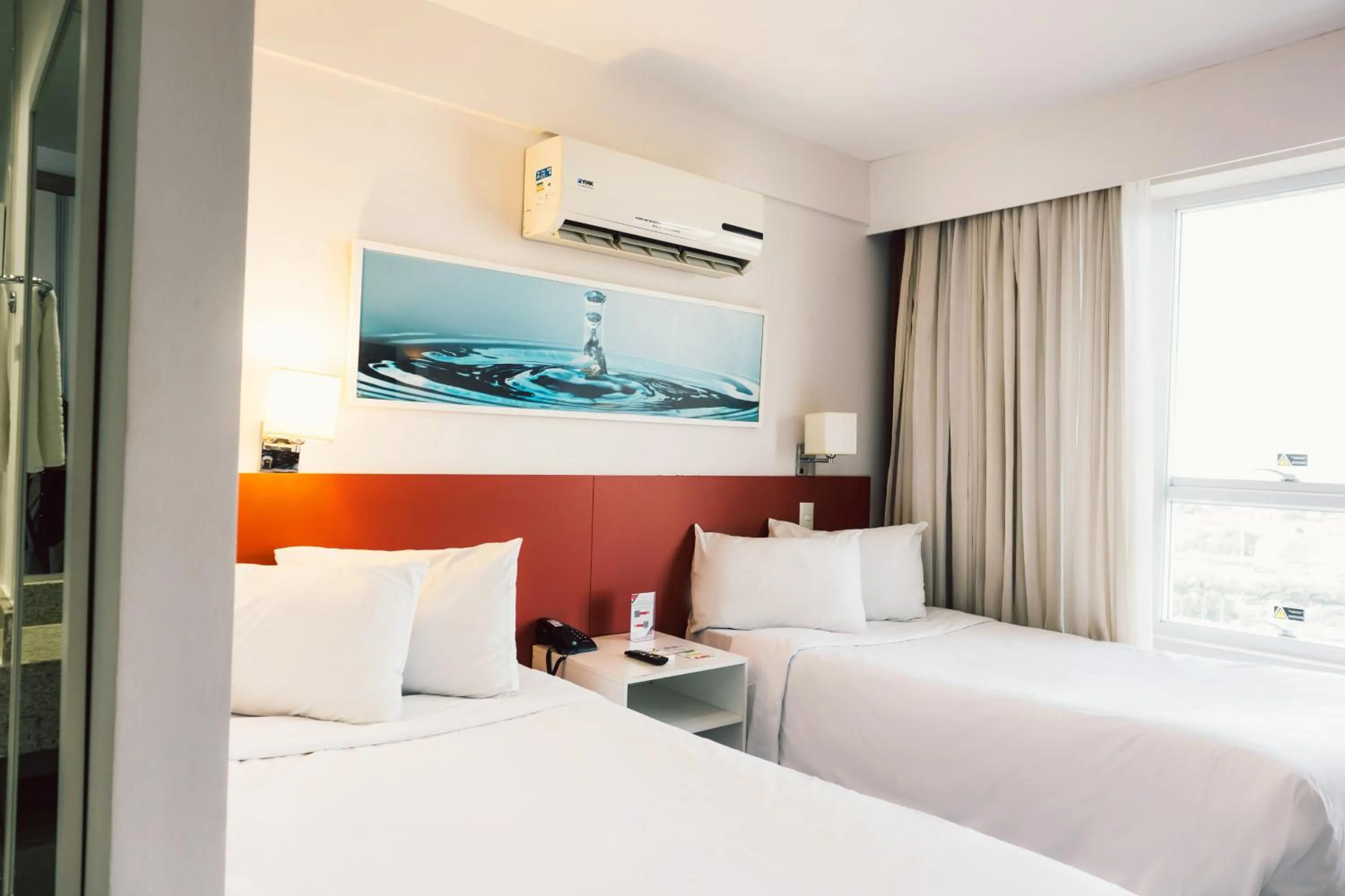 Bed in Ramada Hotel & Suites Campos Pelinca