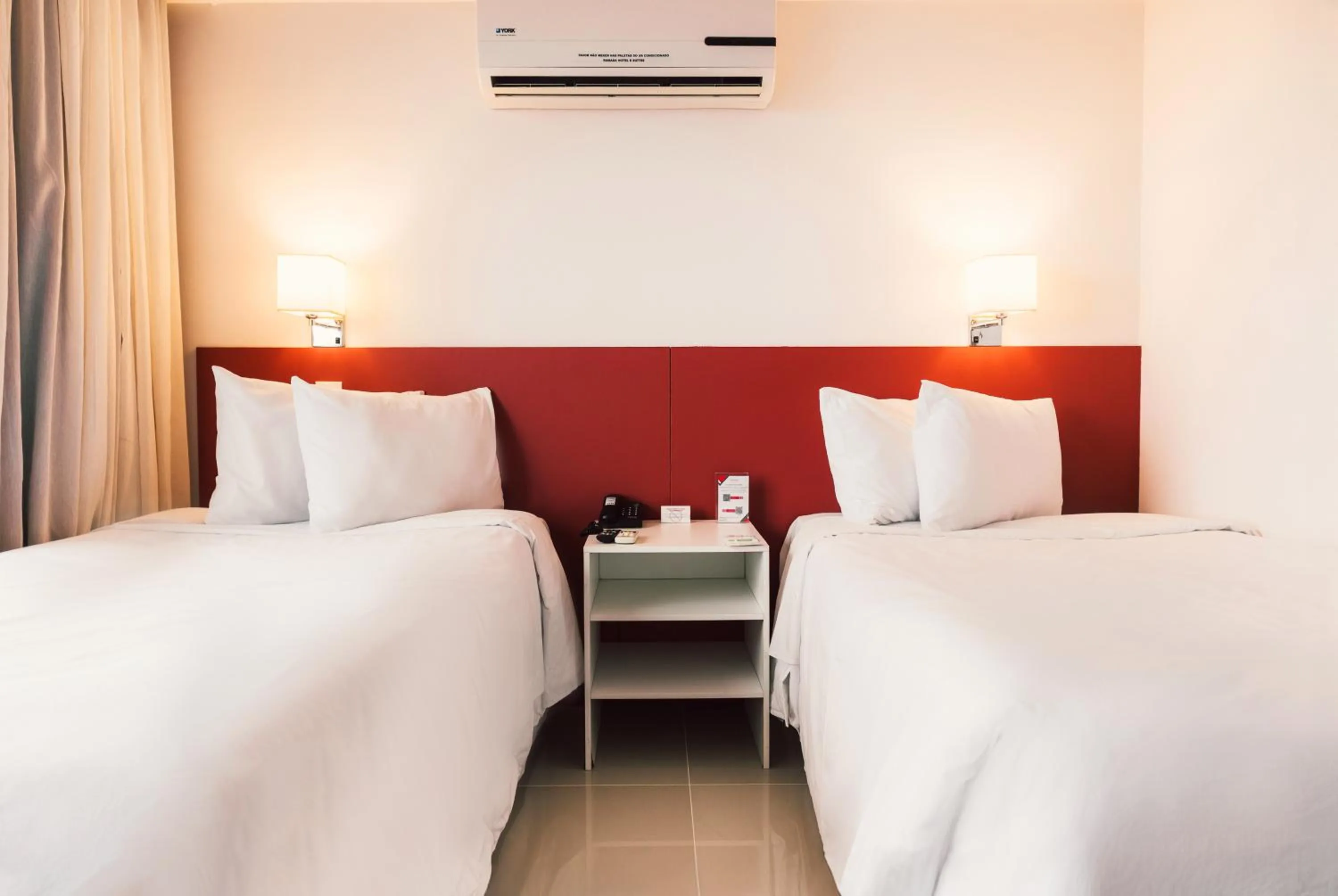 Bed in Ramada Hotel & Suites Campos Pelinca