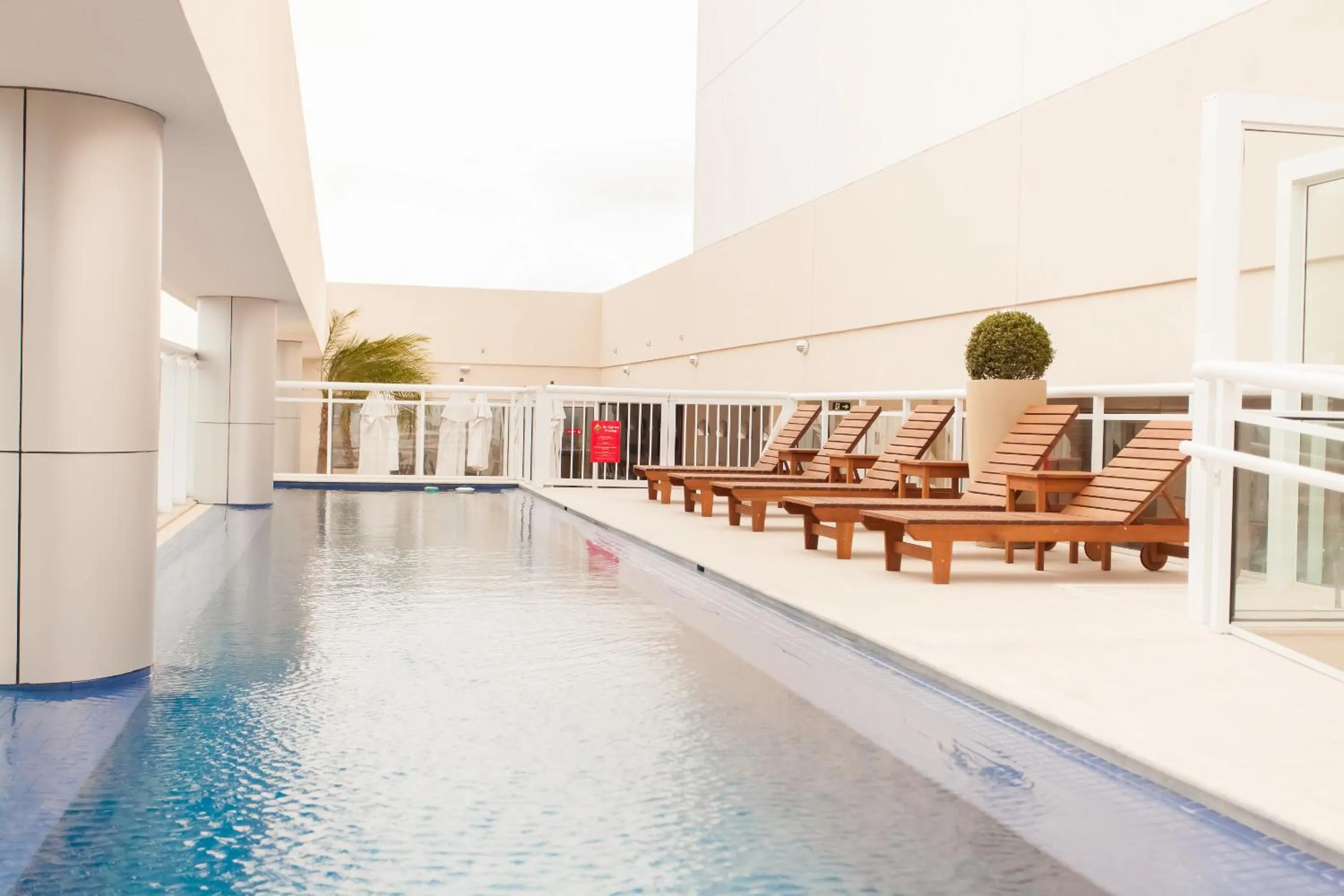 Swimming pool in Ramada Hotel & Suites Campos Pelinca