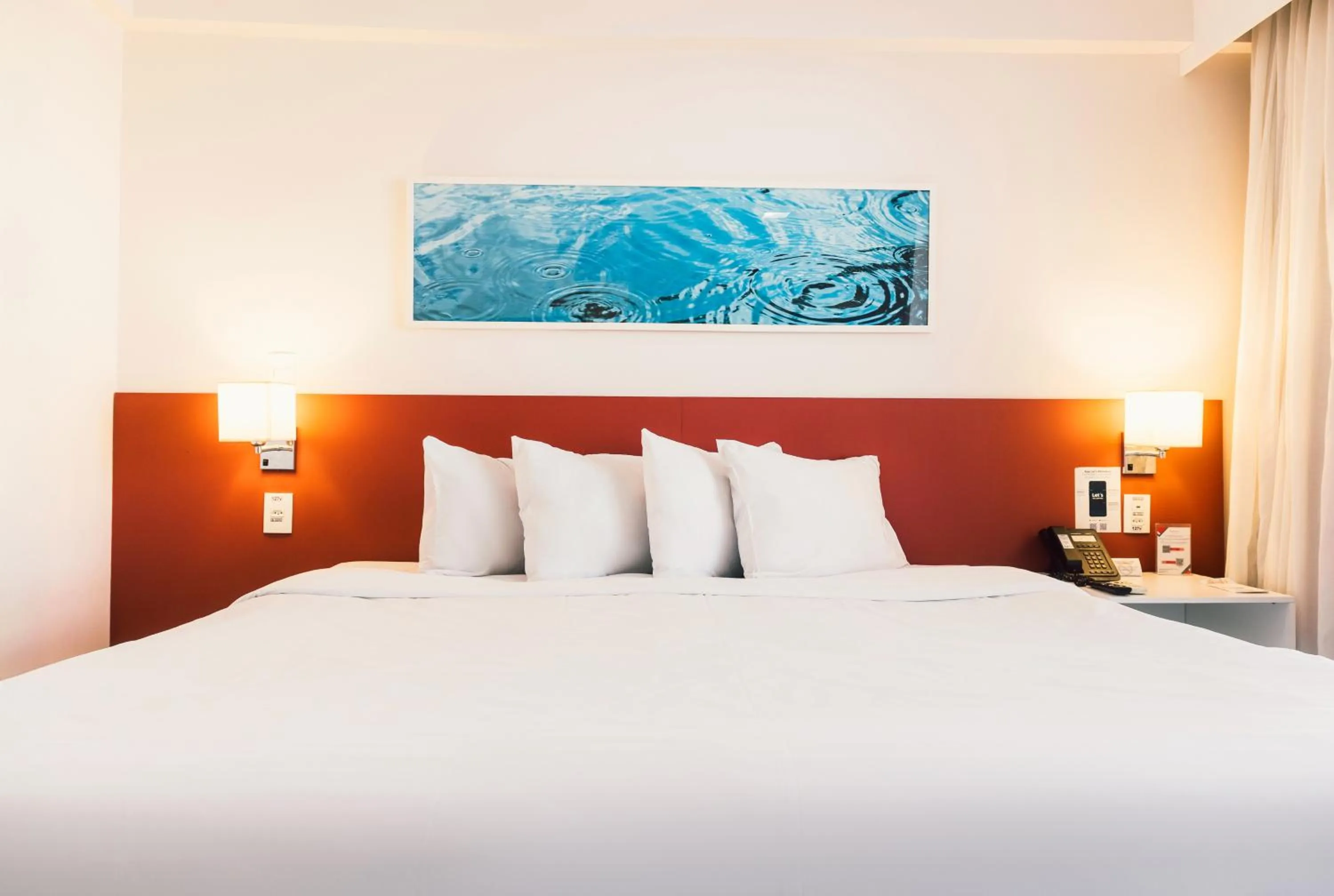 Bed in Ramada Hotel & Suites Campos Pelinca