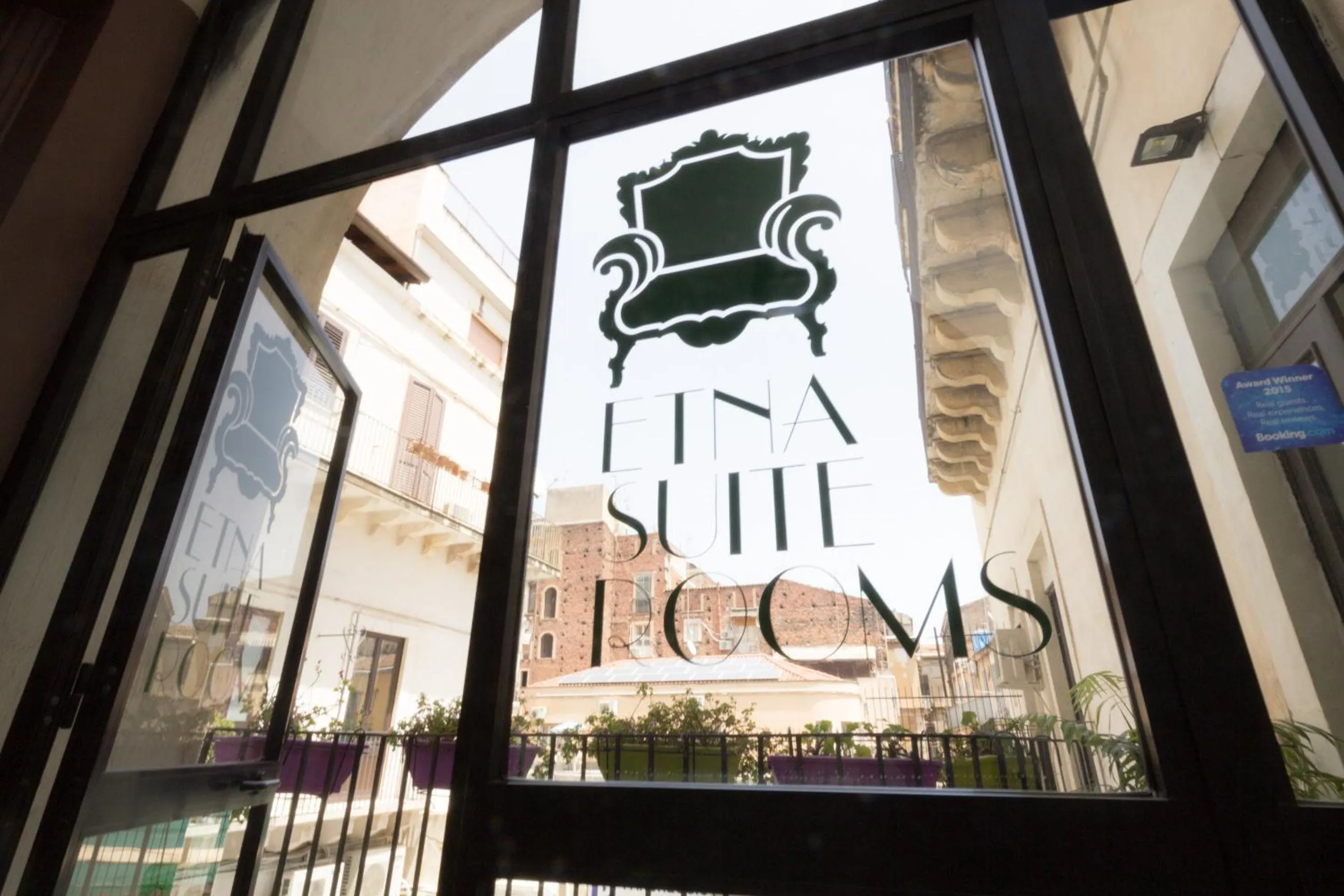 Property logo or sign in Etna Suite Group