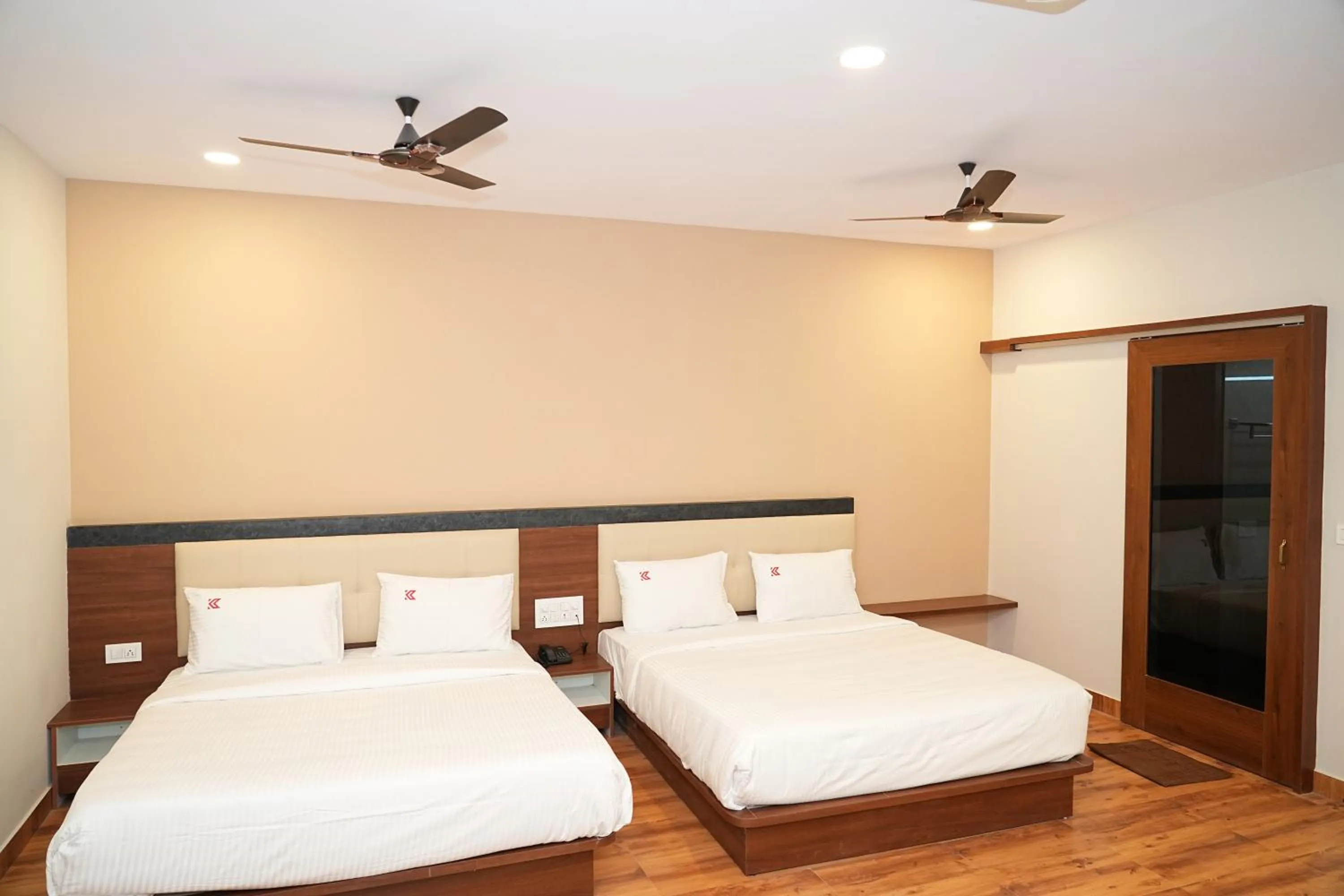 Bed in Hotel Kalyan Suites