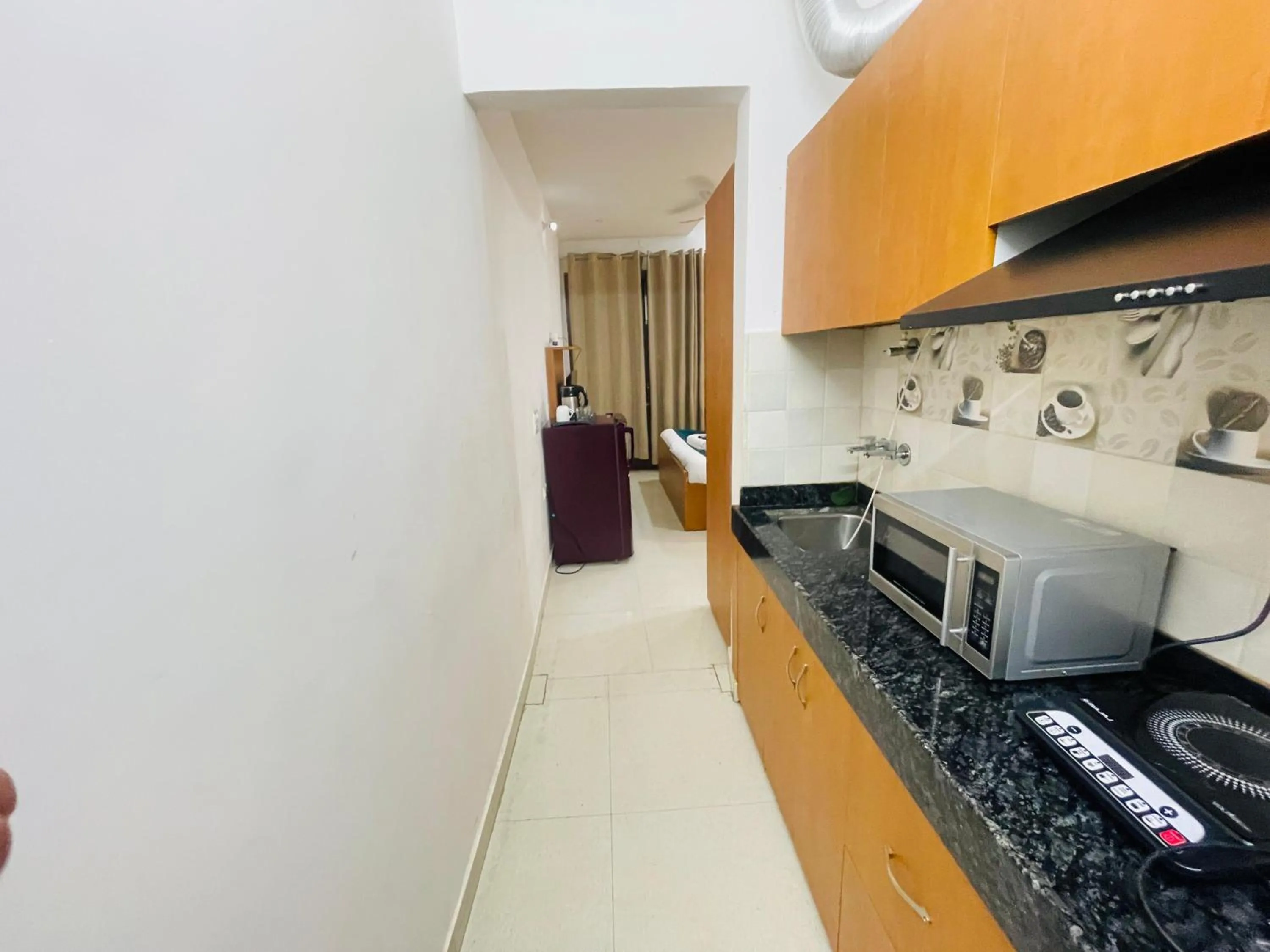 Kitchen or kitchenette in Aura Luxury studios near Artemis hospital Gurugram