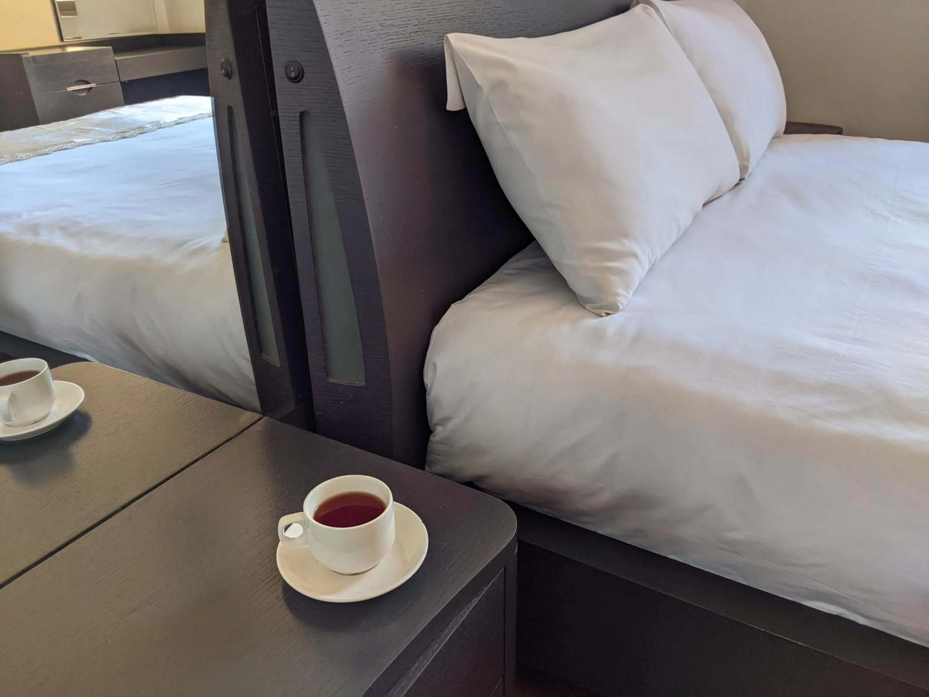 Bed in Prestige Hotel Suites