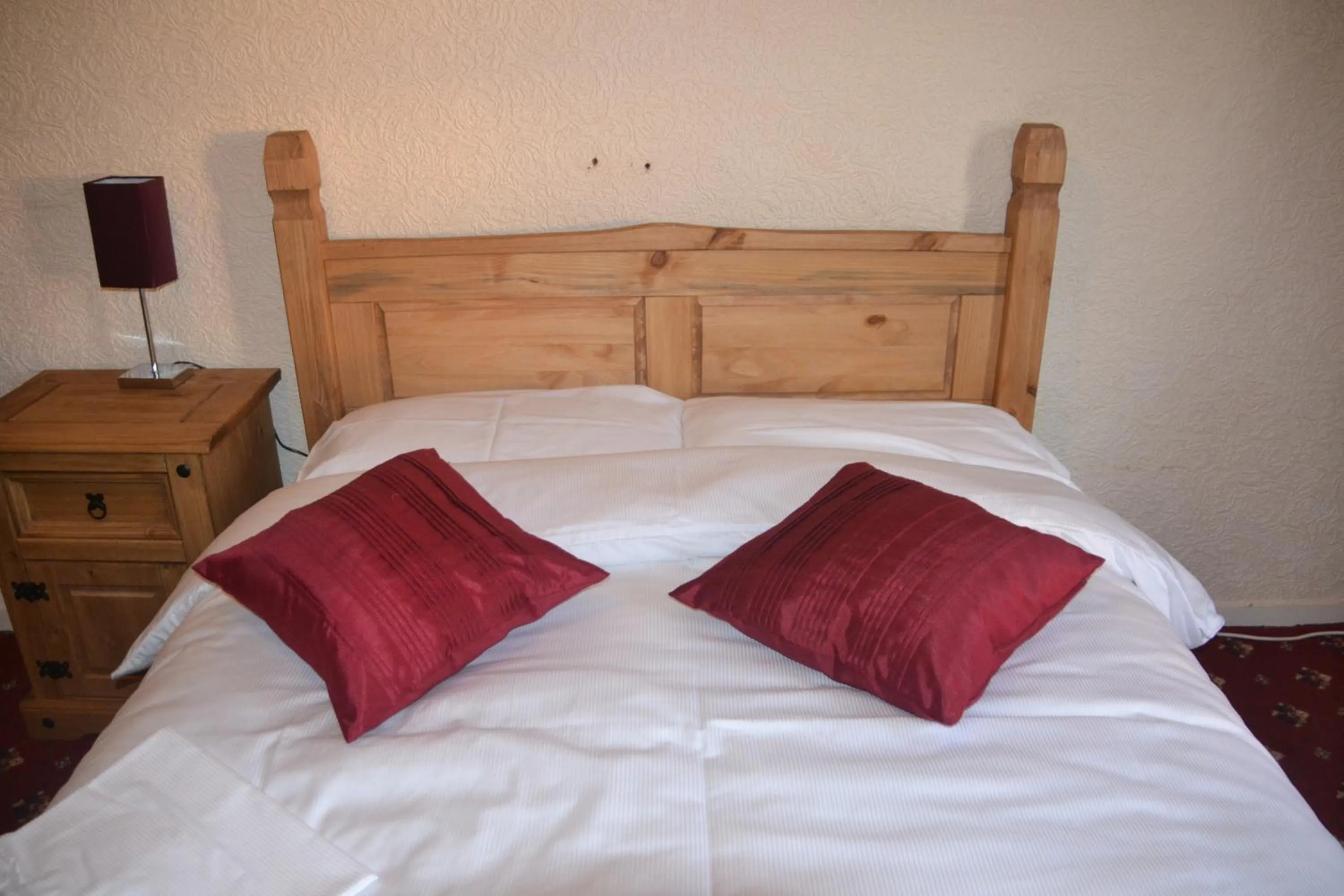 Bed in Camelot Seafront Hotel