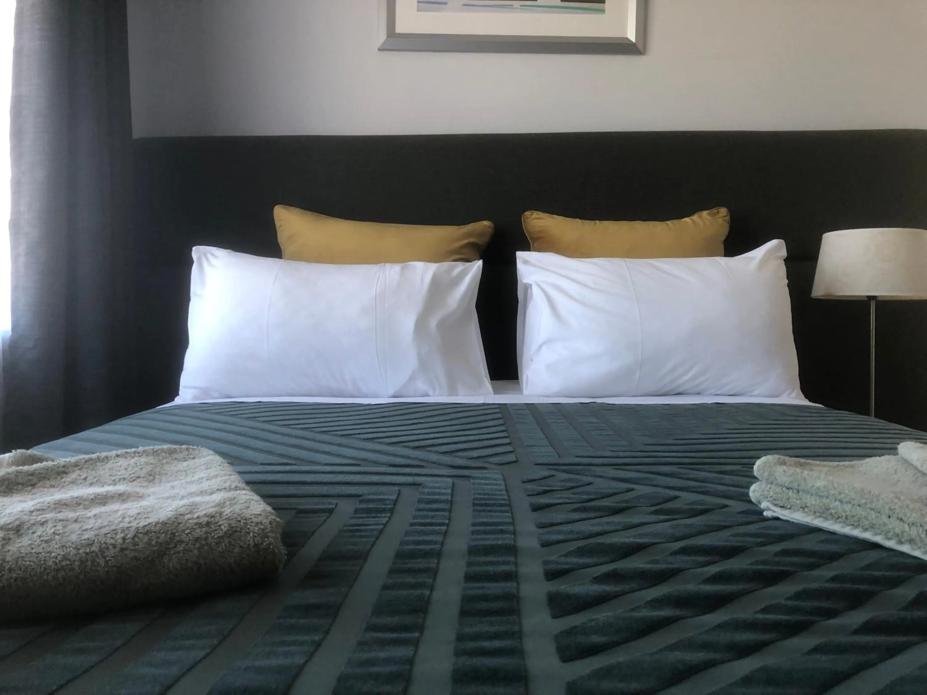 Bed in White Manor Motel