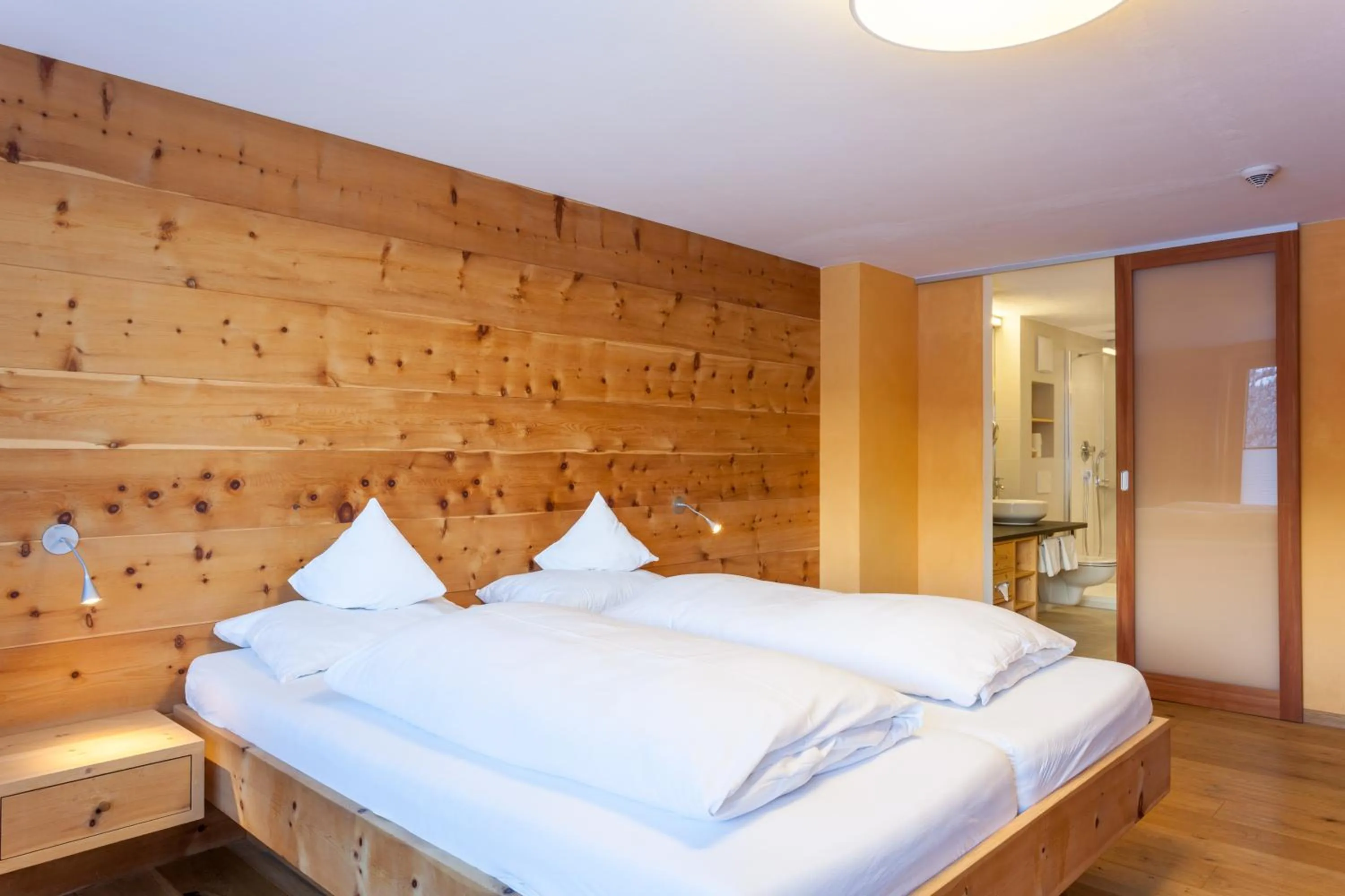 Bed in Biohotel Mattlihüs