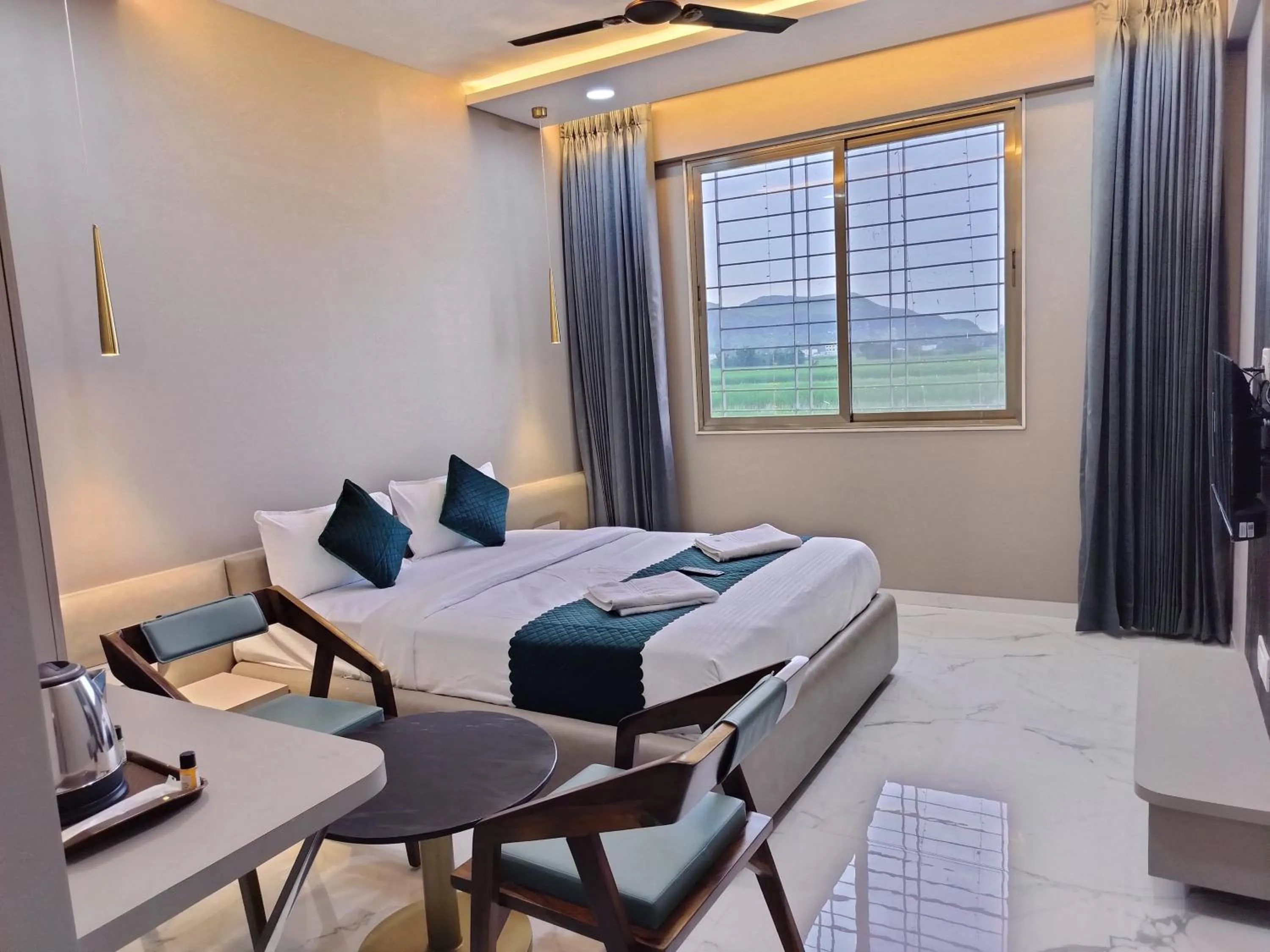 Seating area, Bed in Hotel Laxmi Elite Karad