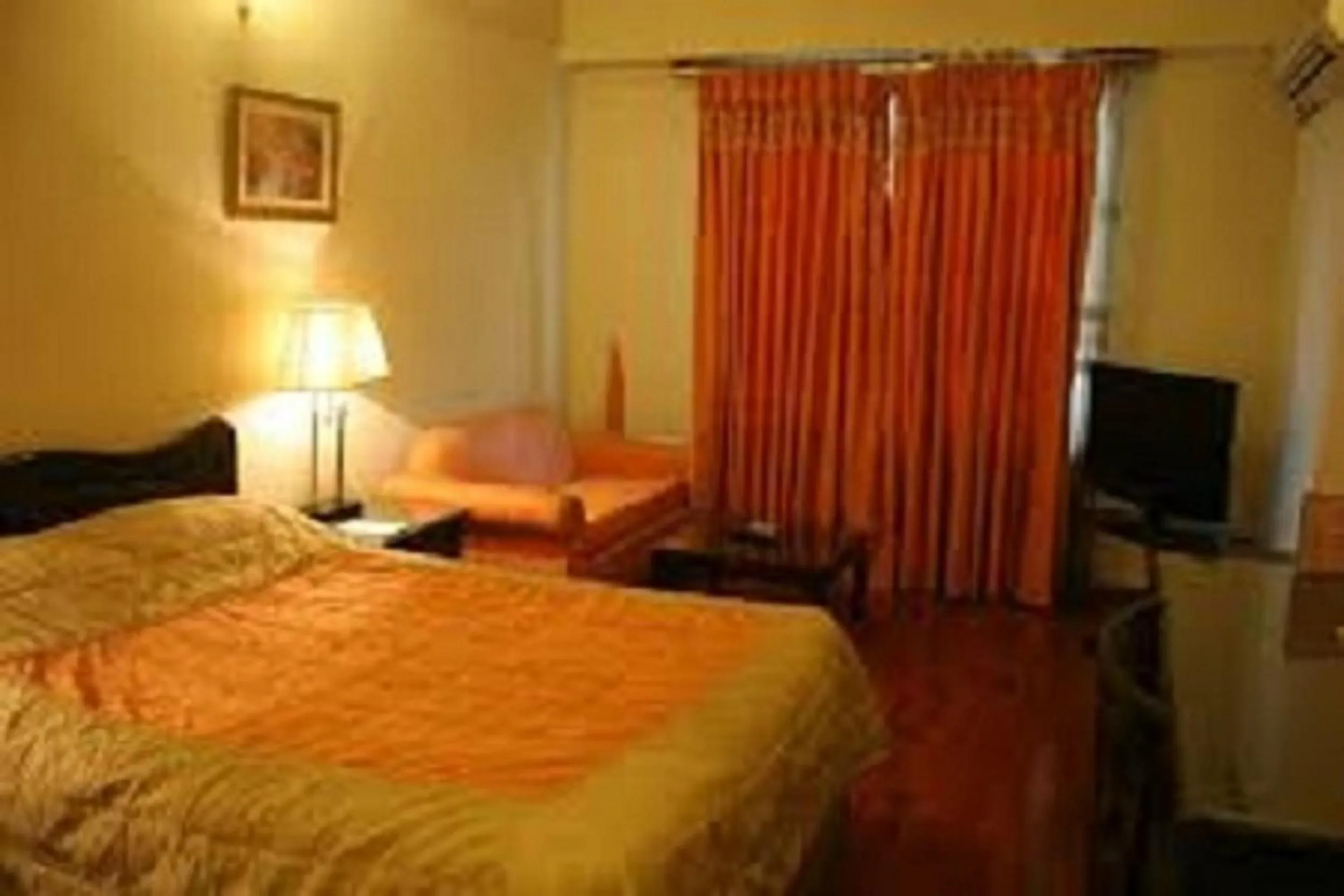 Bed in Carlton Tower Hotel Lahore