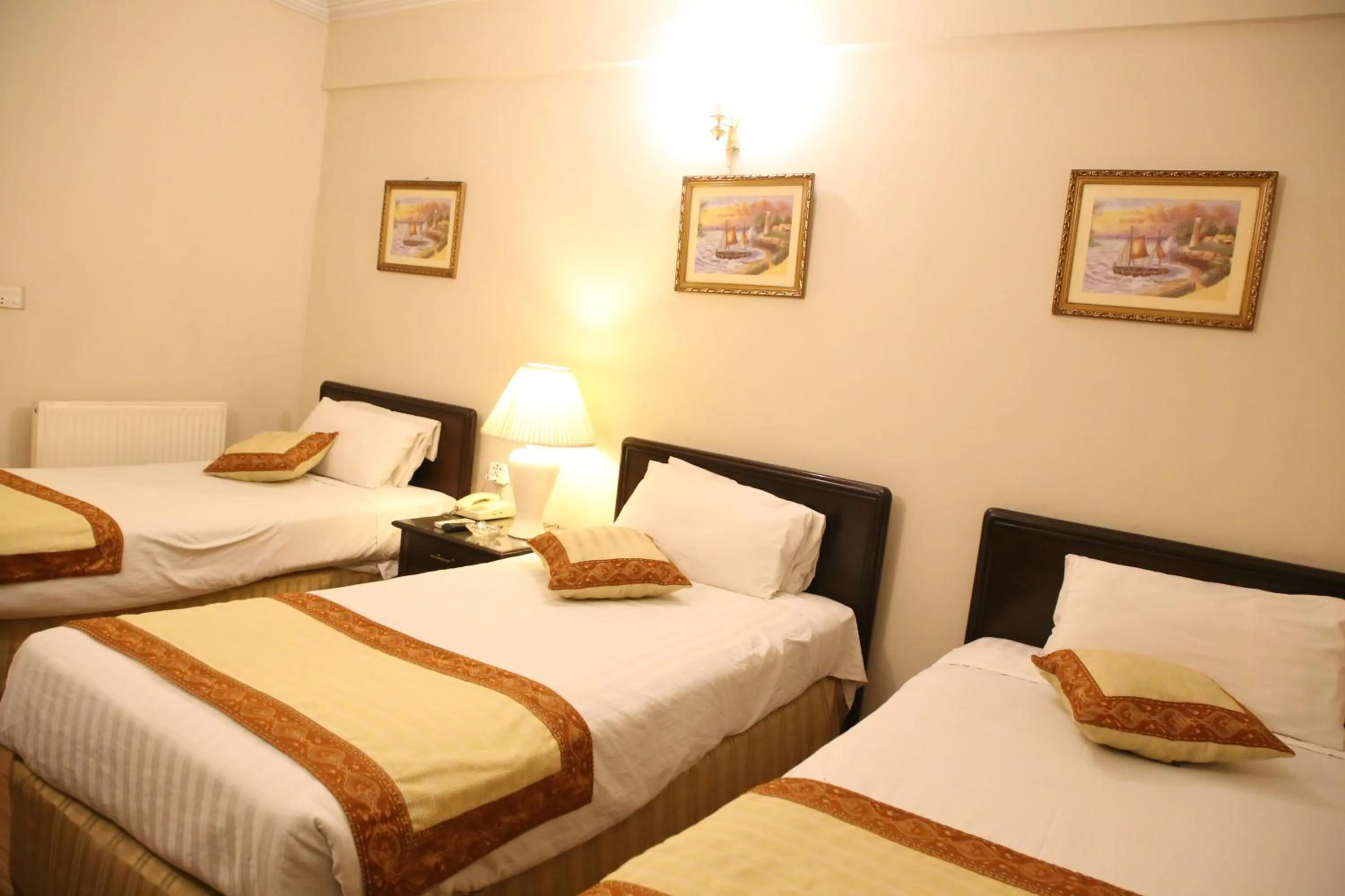 Bed in Carlton Tower Hotel Lahore