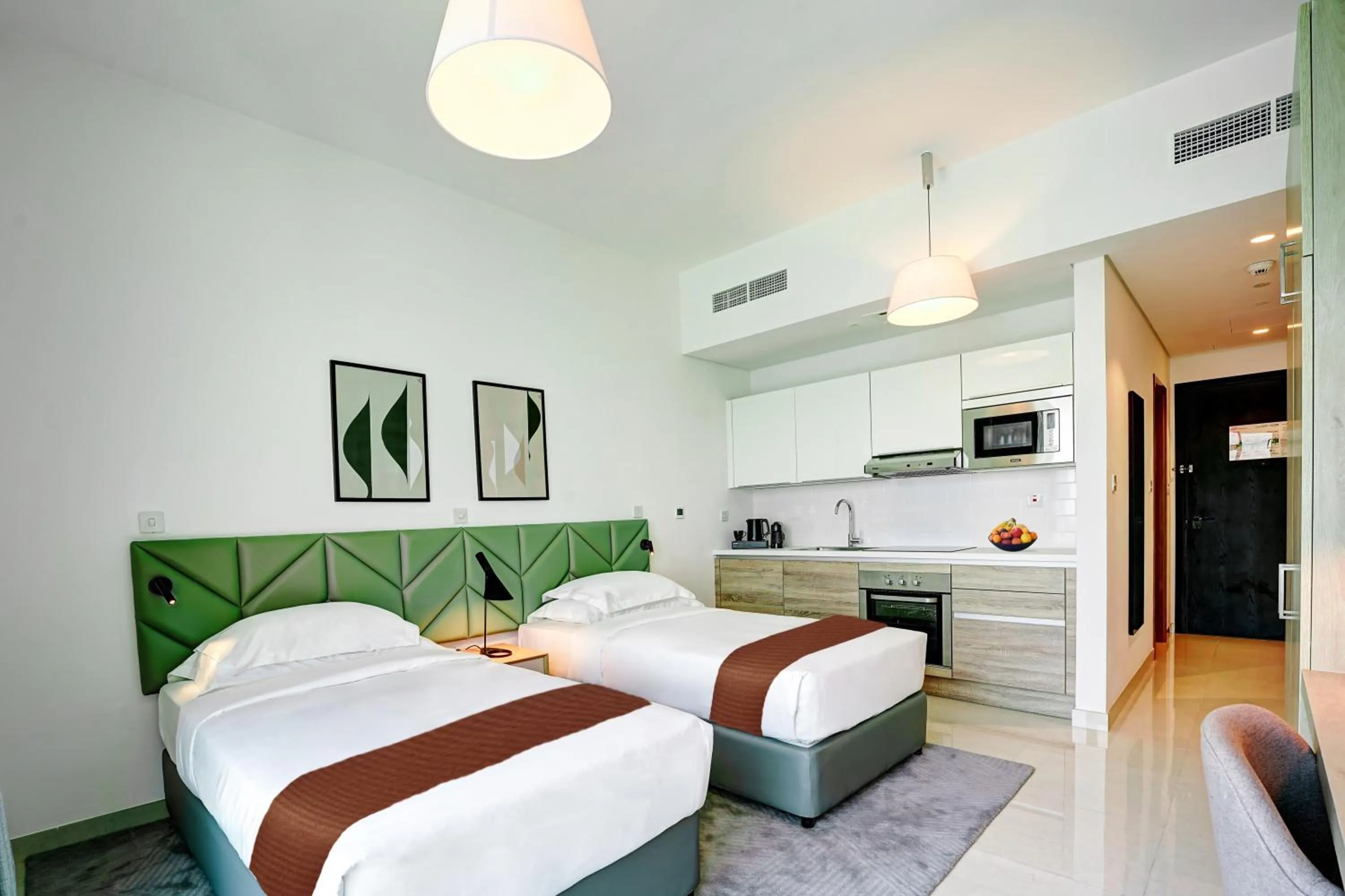 Kitchen or kitchenette, Bed in Capital Suites Hotel Apartments