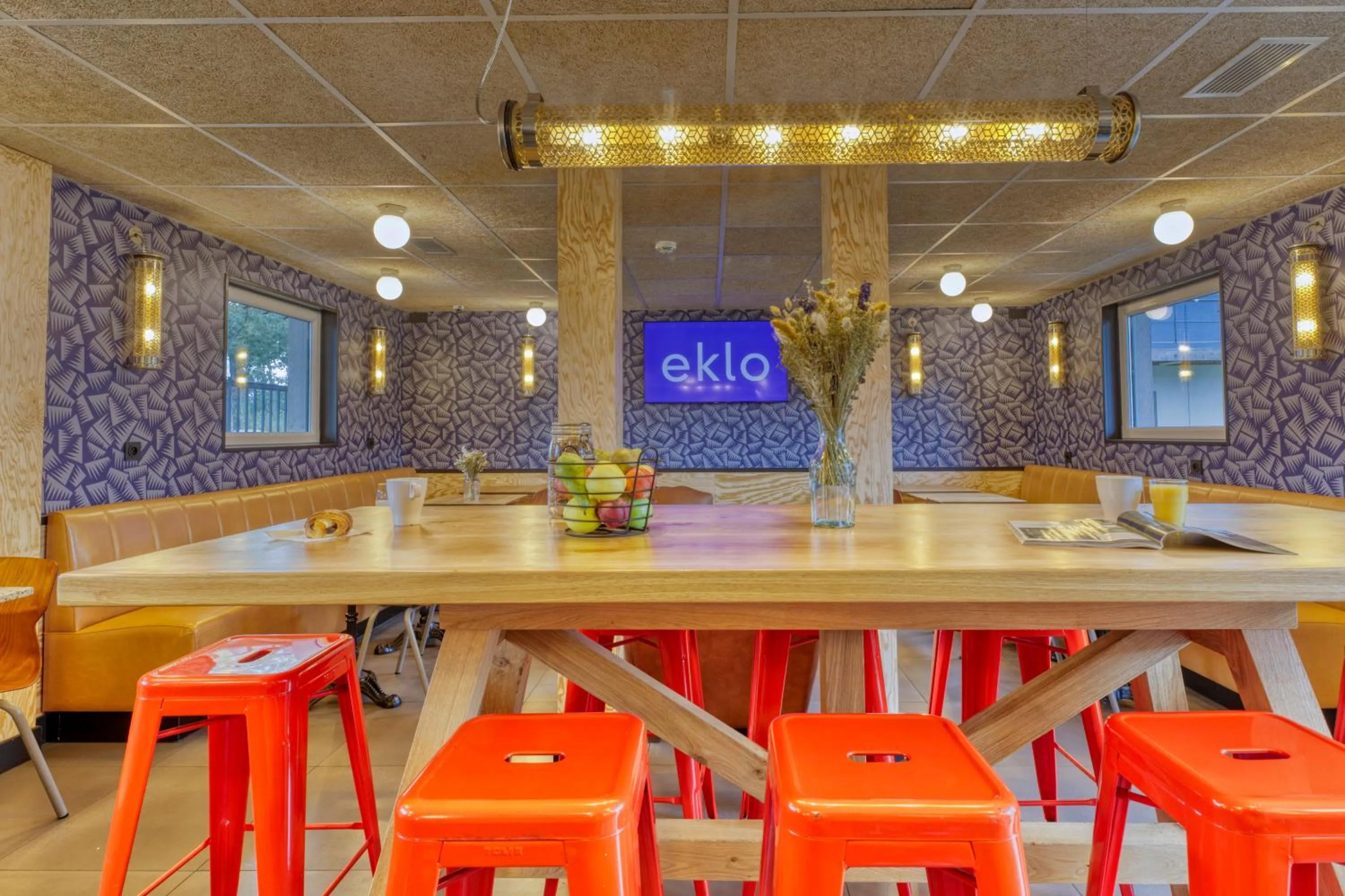 Communal lounge/ TV room in Eklo Hotels Le Havre