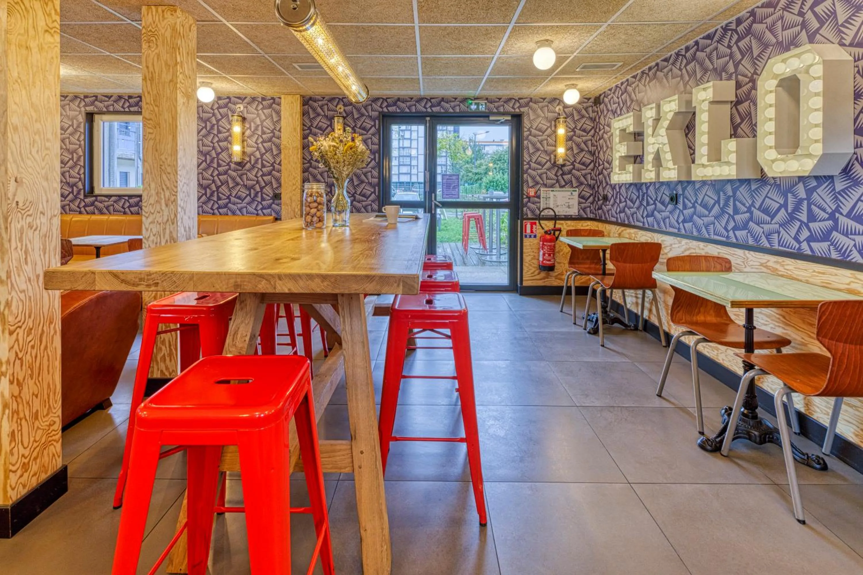 Communal lounge/ TV room in Eklo Hotels Le Havre