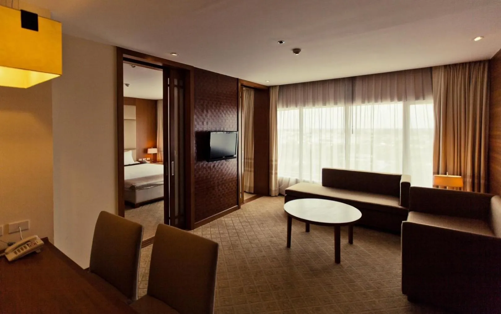 Living room, Bed in Sunee Grand Hotel and Convention Center