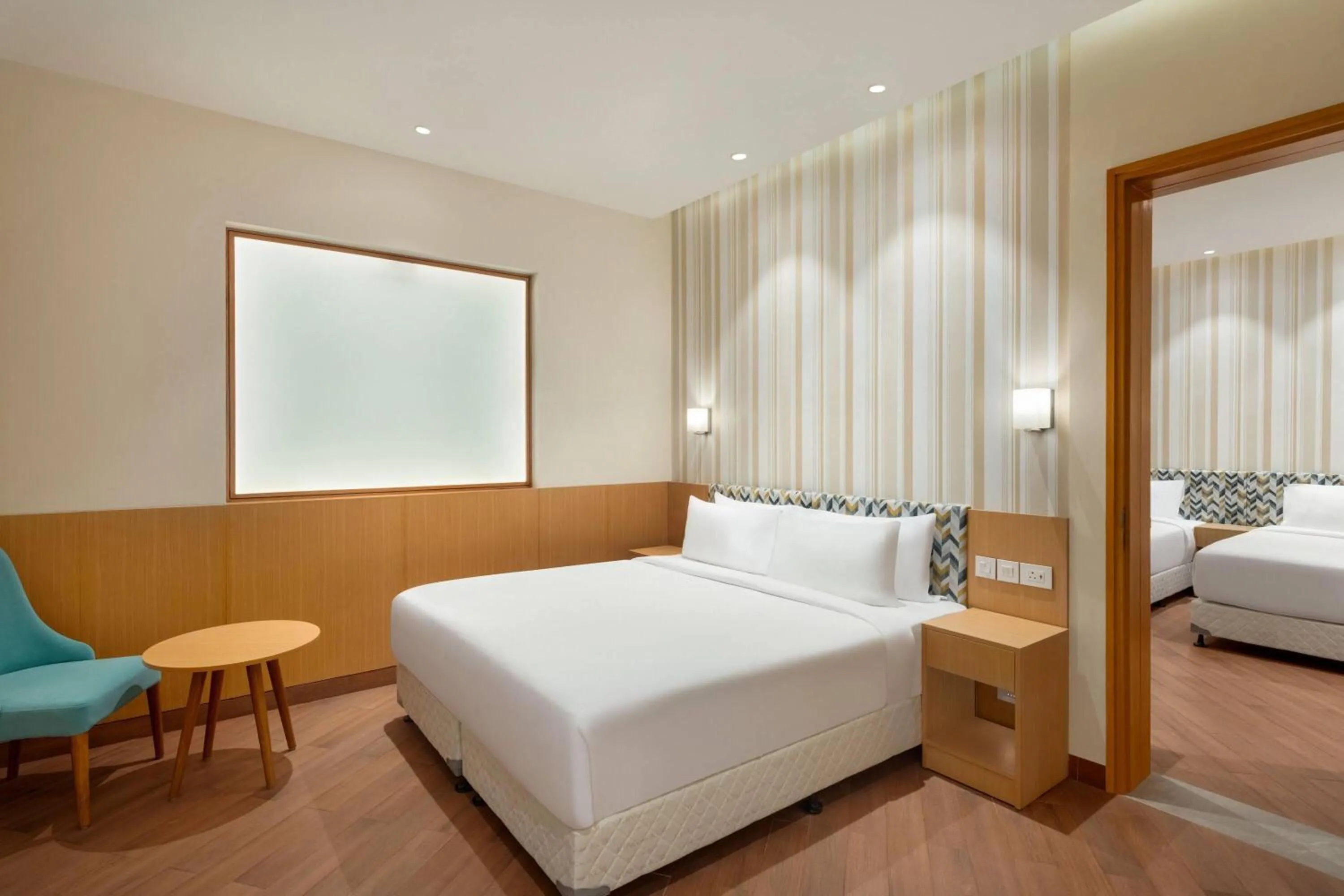 Photo of the whole room, Bed in Ramada Encore by Wyndham Lucknow Airport