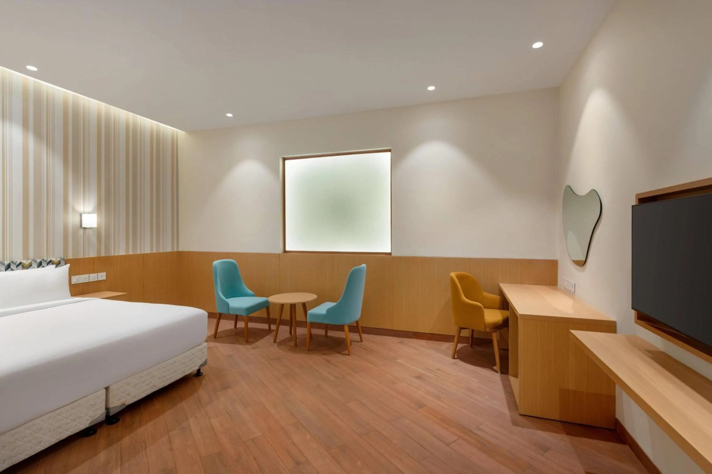 Photo of the whole room, Bed in Ramada Encore by Wyndham Lucknow Airport
