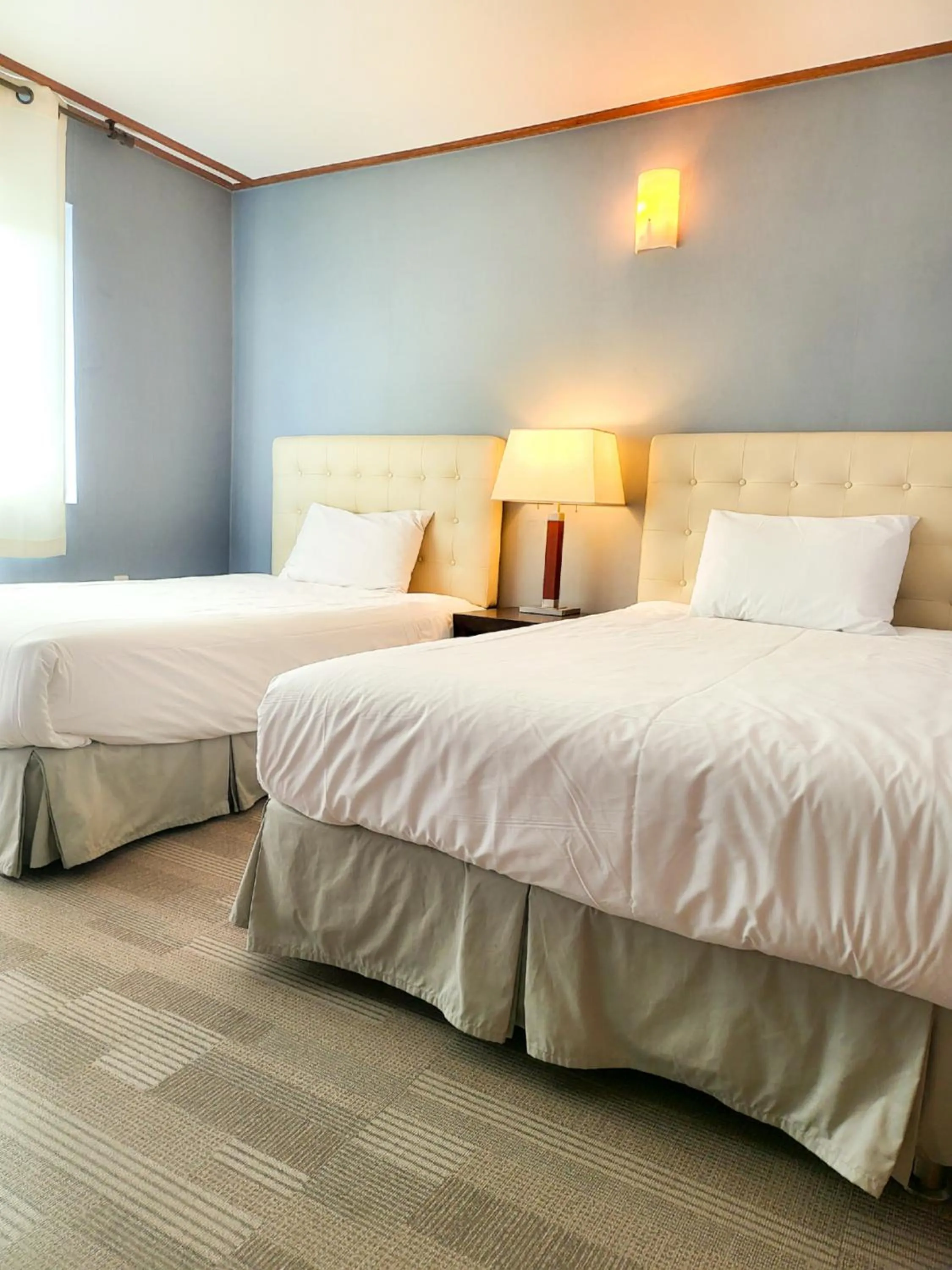 Bed in Jeju EQ Stay Hotel