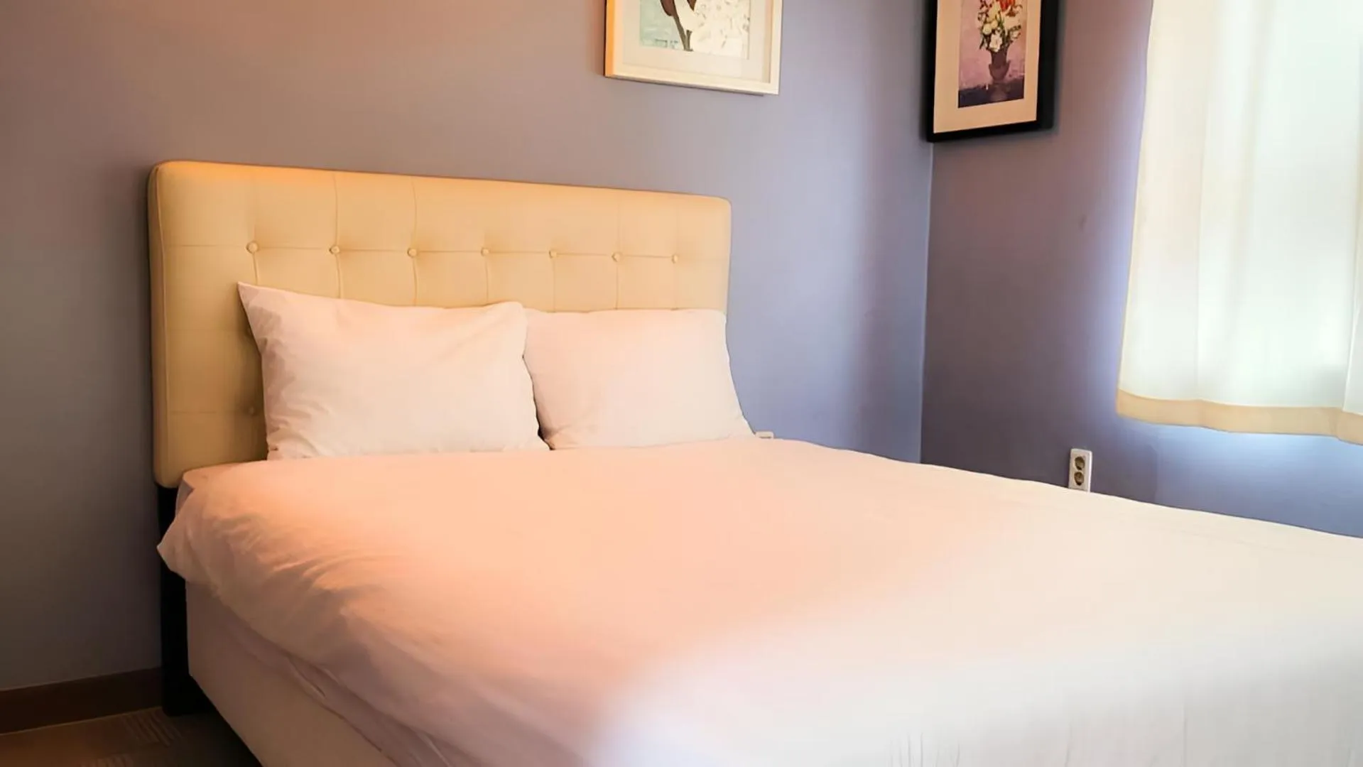 Bed in Jeju EQ Stay Hotel