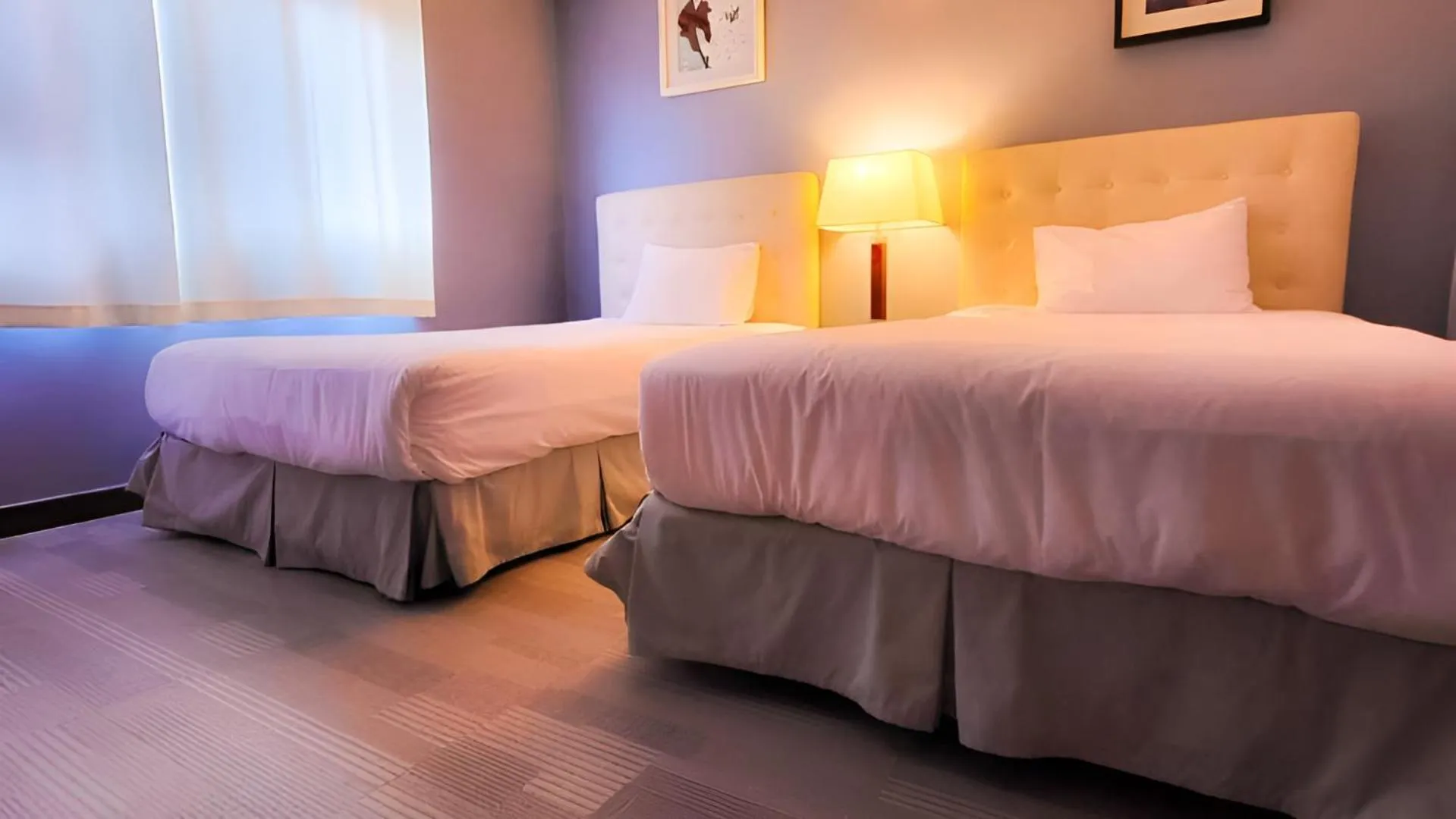 Bed in Jeju EQ Stay Hotel