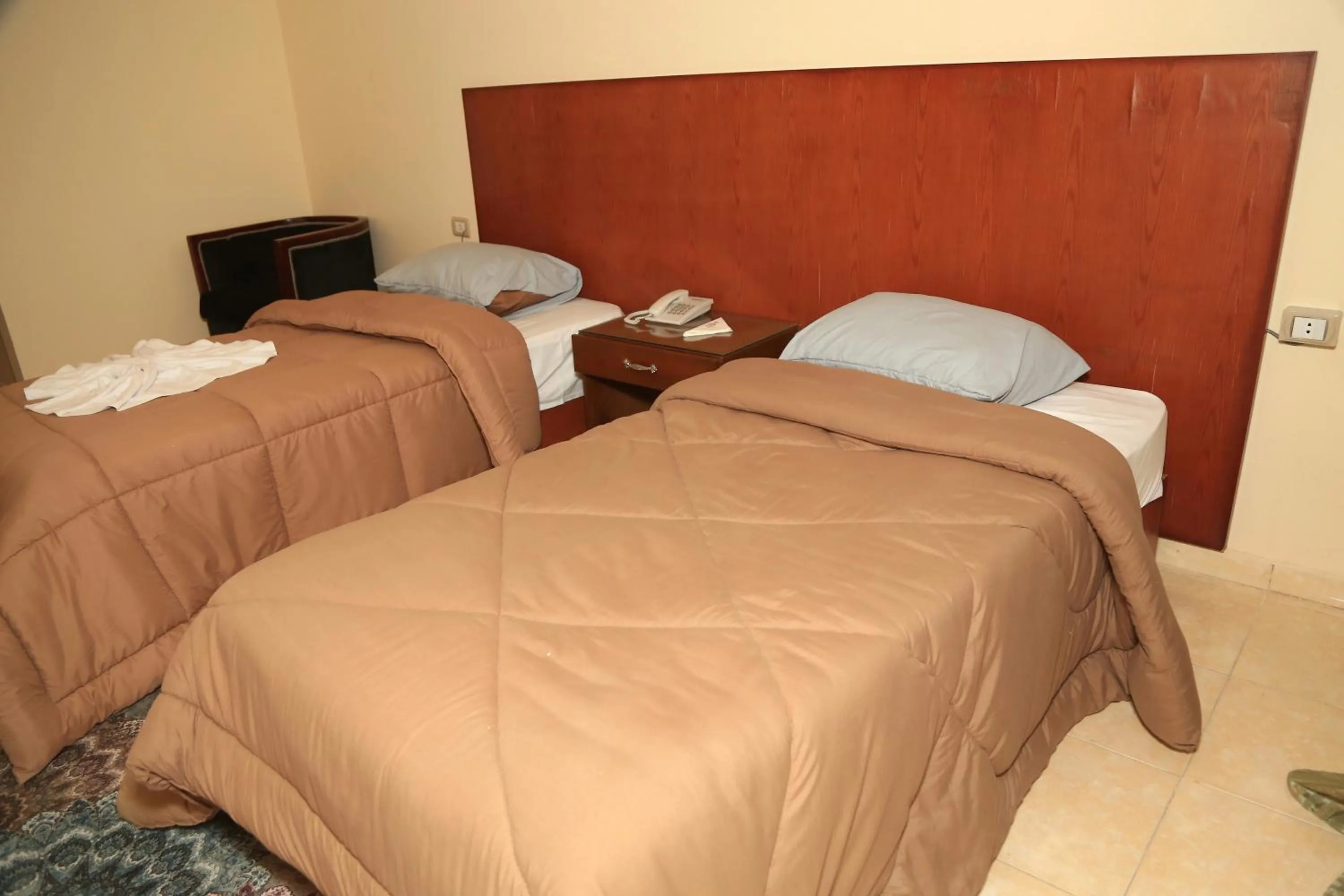 Bed in Verssailles Pyramids Hotel