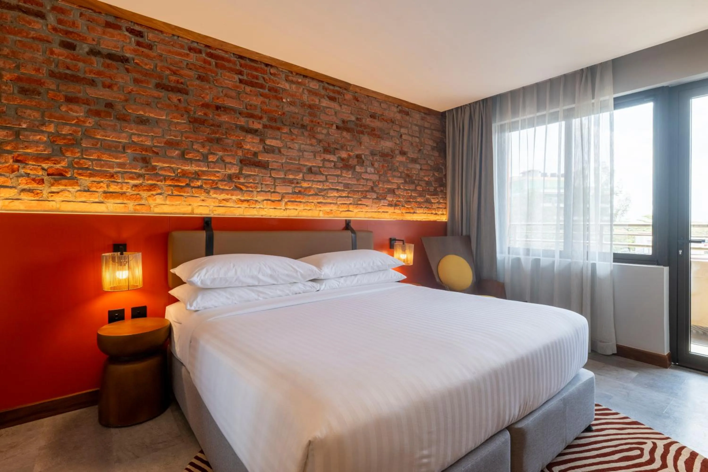 Bed in Zaria Court Kigali, Tapestry Collection by Hilton