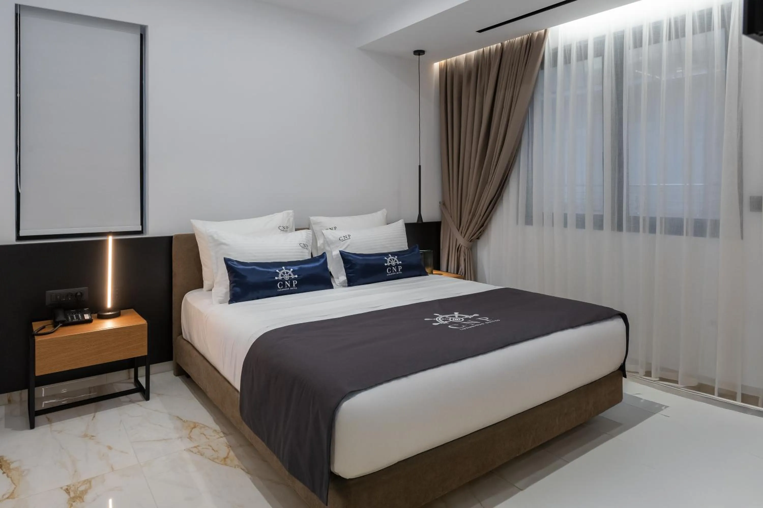 Bed in Captain Napoleon Paterakis CNP Luxurious Suites