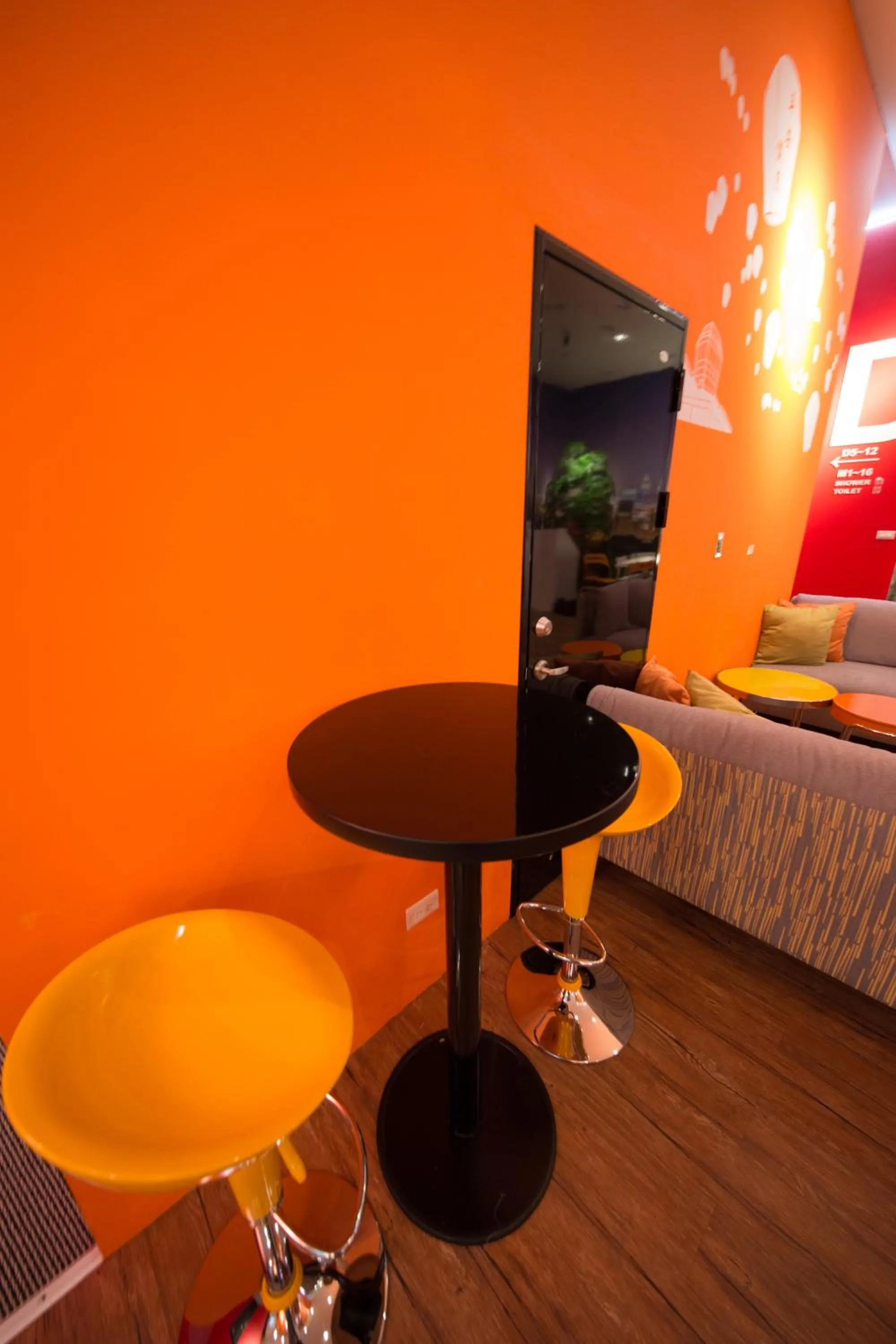 Seating area, Bed in SleepBox Hostel