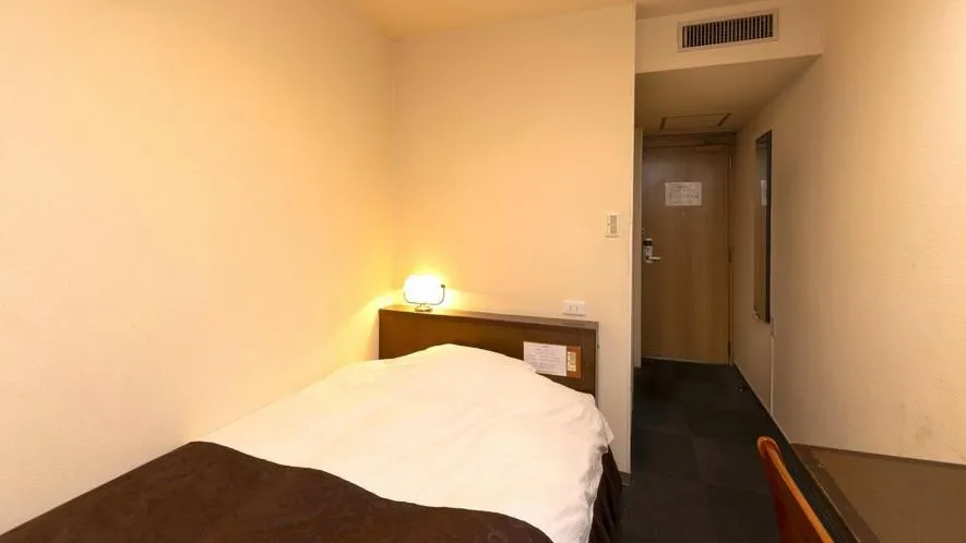 Bed in New Gloria Oita Hotel