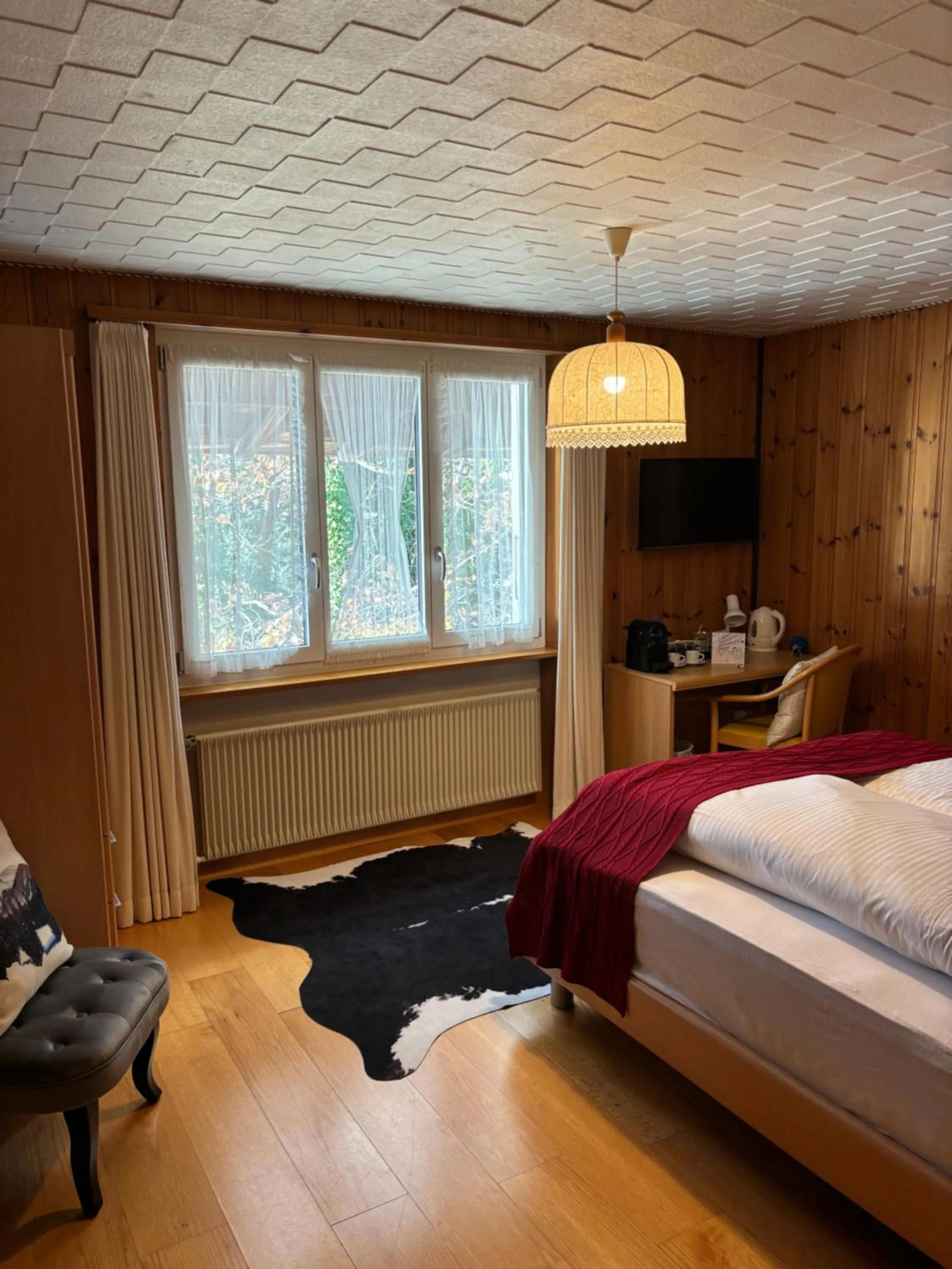 Photo of the whole room, Bed in Alpina Boutique Hotel Interlaken - Ringgenberg - Adults only !