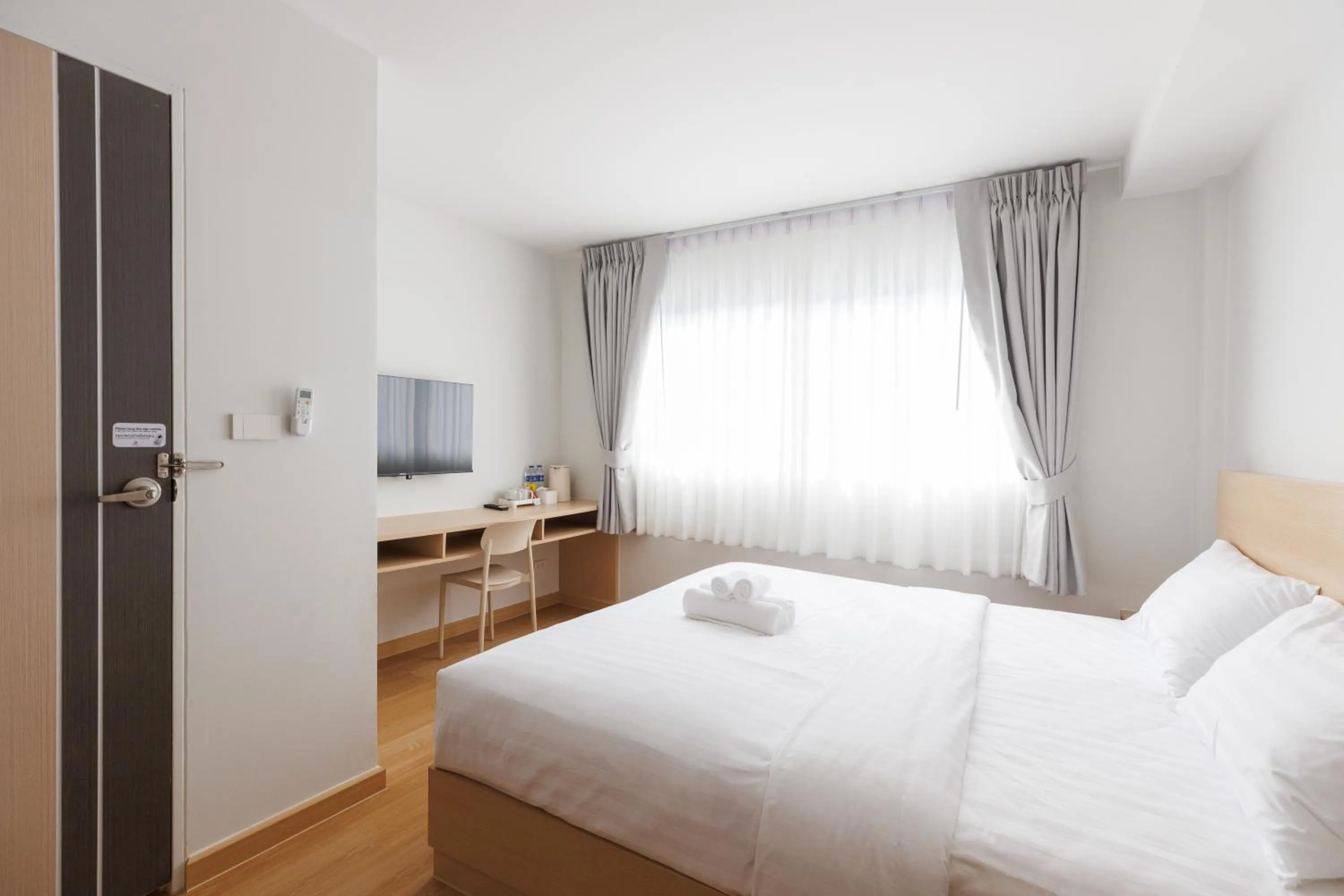 Communal lounge/ TV room, Bed in Takka Hotel - Bearing