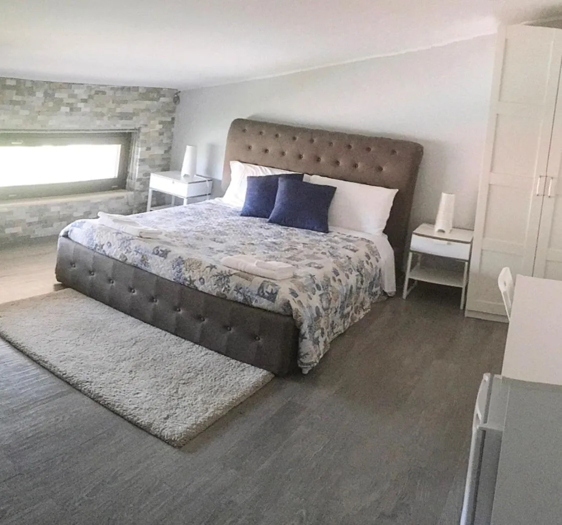 Bed in Pietra Bianca Rooms