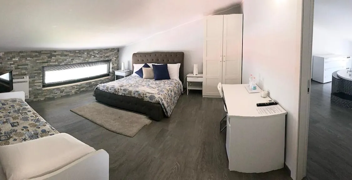 Bed in Pietra Bianca Rooms