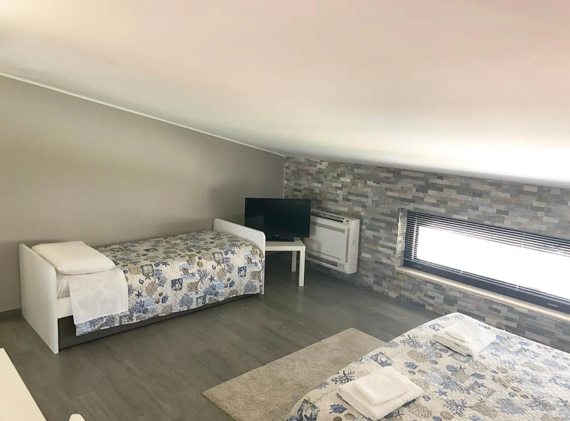 Bed in Pietra Bianca Rooms