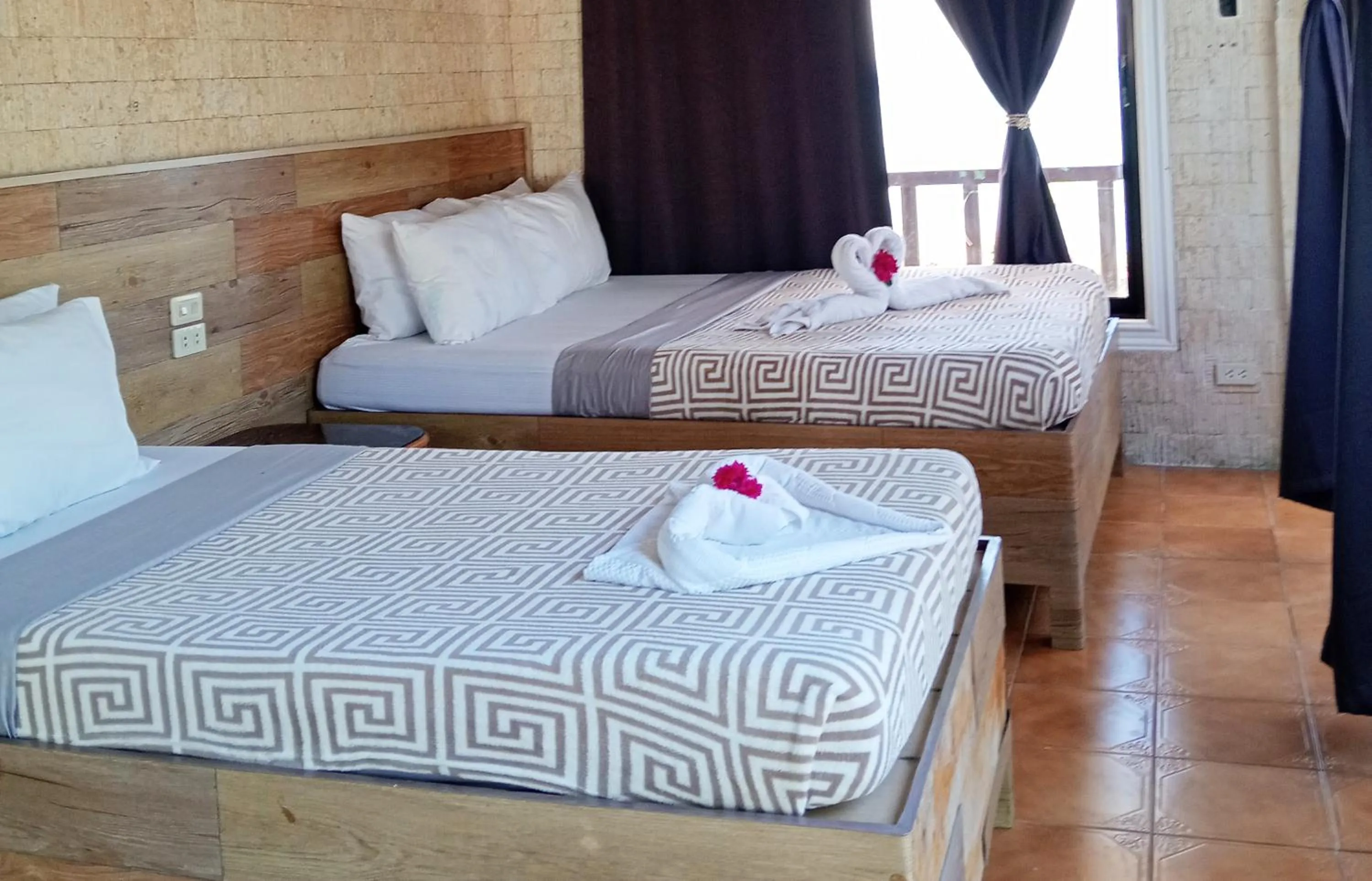 Bed in Nalusuan Island Resort and Marine Sanctuary