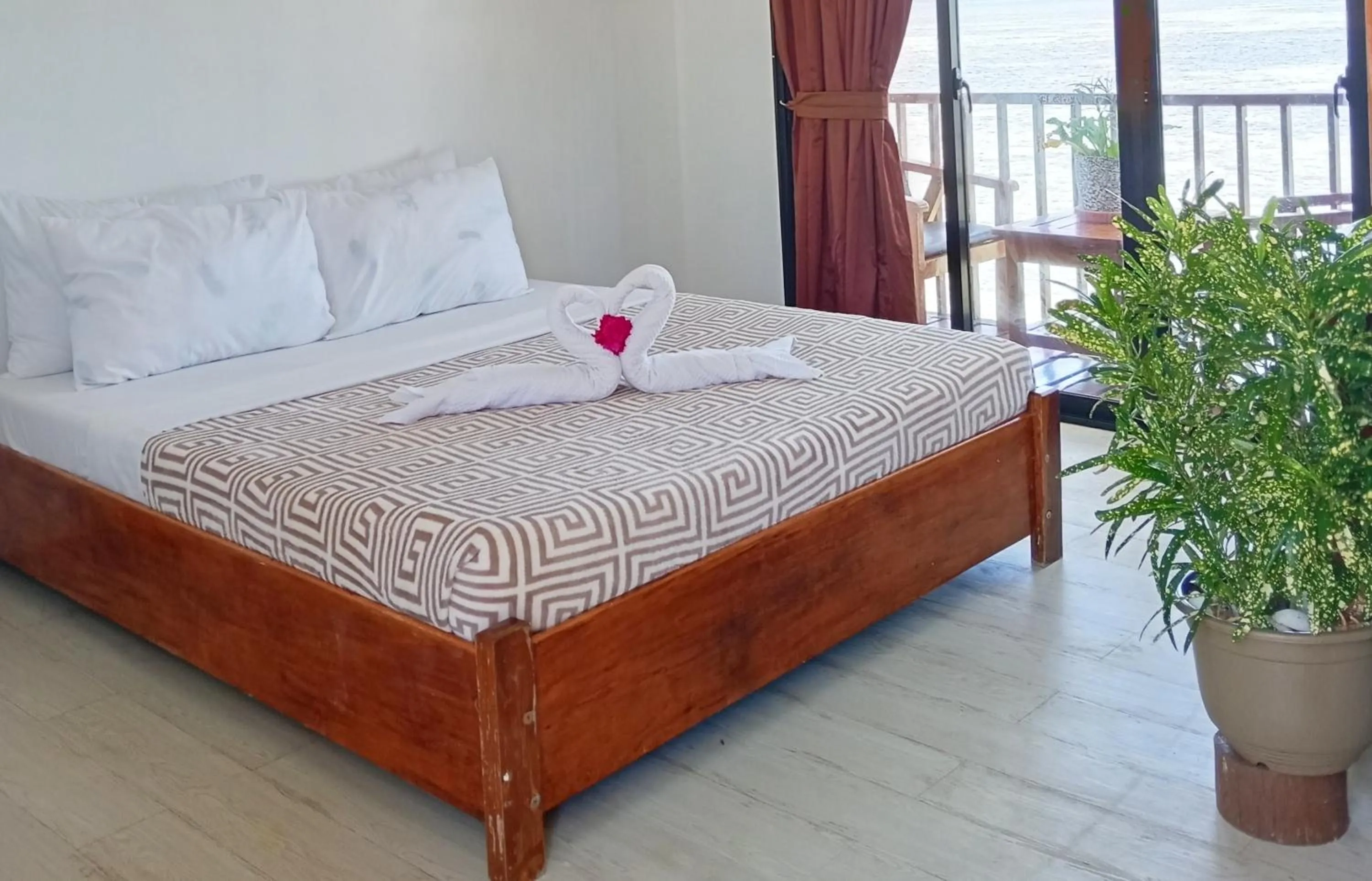 Bed in Nalusuan Island Resort and Marine Sanctuary