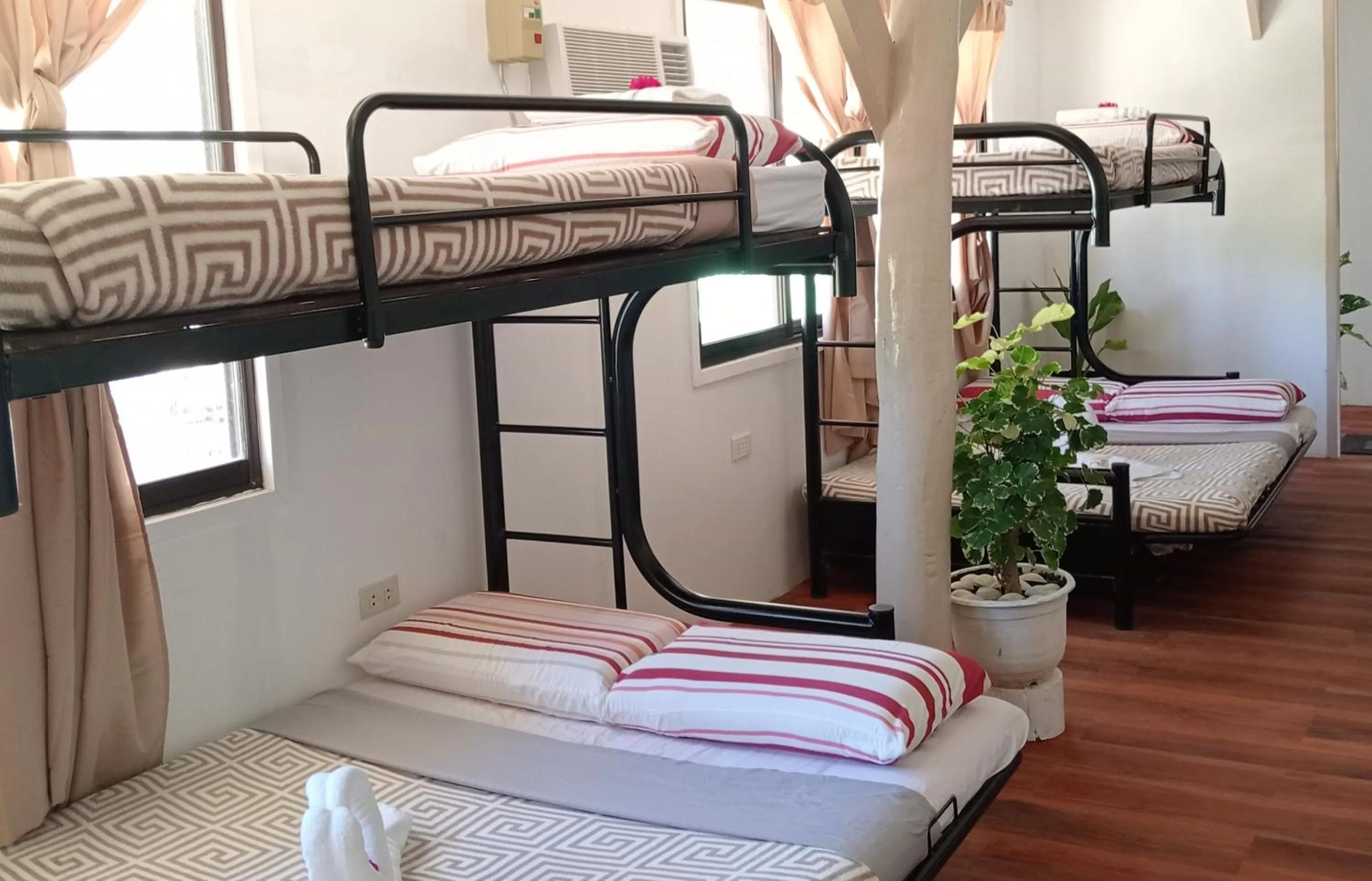 Bed in Nalusuan Island Resort and Marine Sanctuary