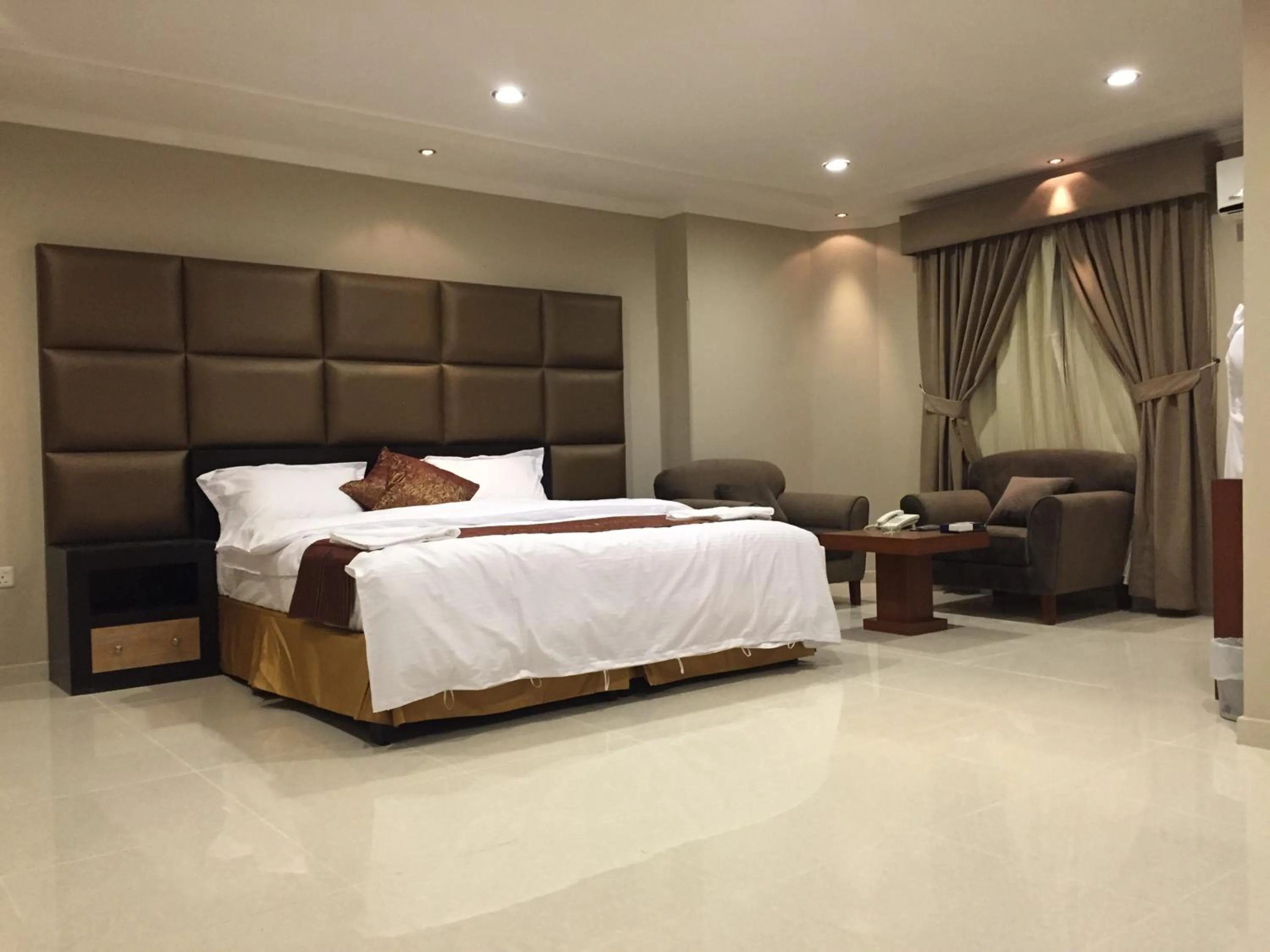 Bed in Ashbonh Hotel Suites