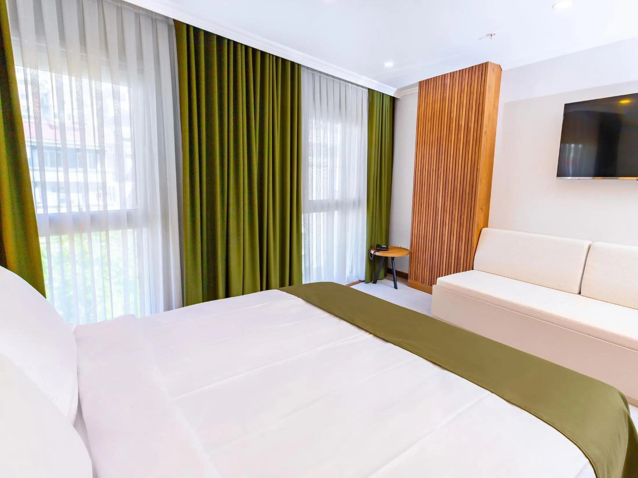 Communal lounge/ TV room, Bed in Quinnova Hotel