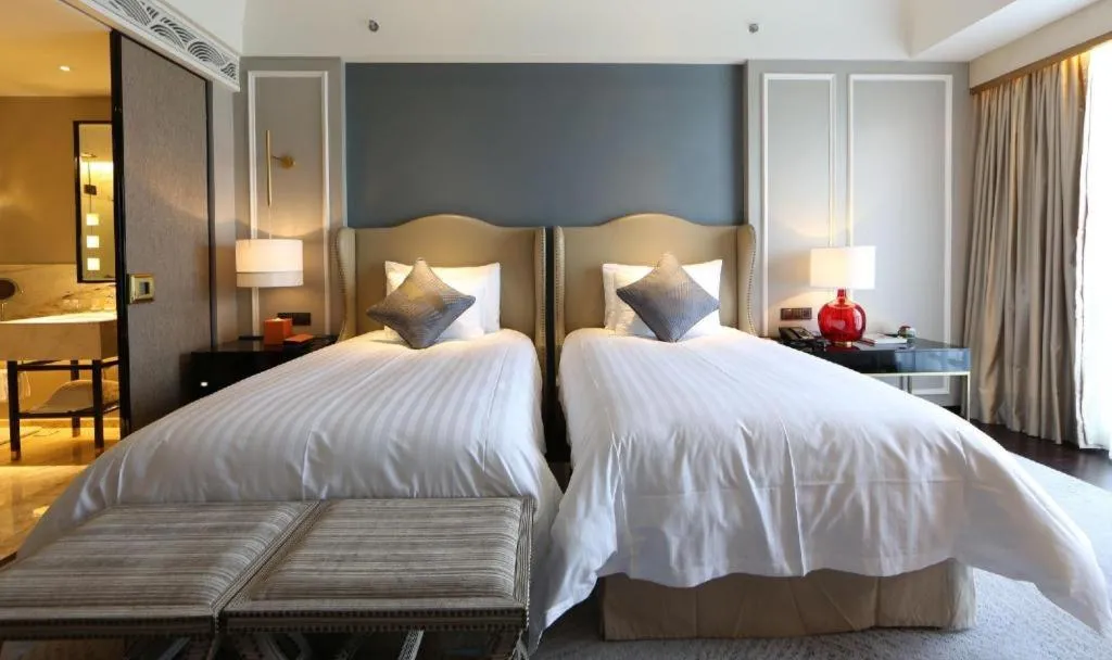 Bed in Grand New Century Hotel Yixing