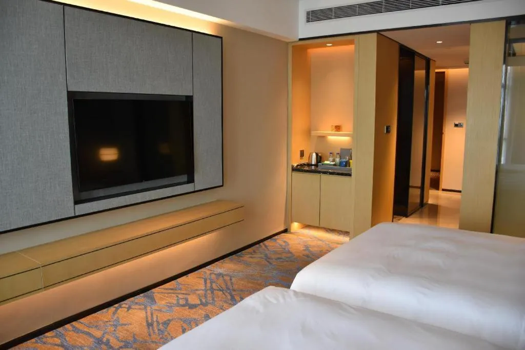 Bed in Zhuhai Tangyi Hotel