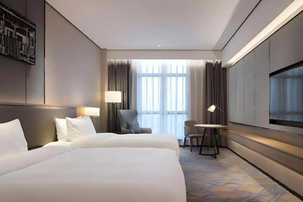 Bed in Zhuhai Tangyi Hotel