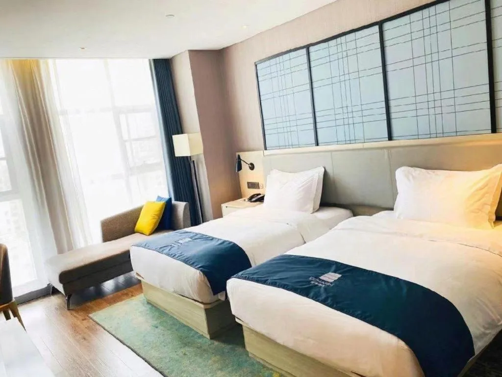 Bed in Echarm Hotel Xiantao Yuantai Weilaicheng