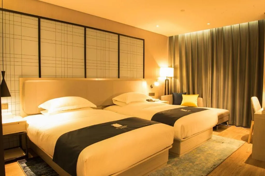 Bed in Echarm Hotel Xiantao Yuantai Weilaicheng