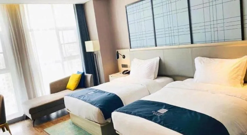 Bed in Echarm Hotel Xiantao Yuantai Weilaicheng