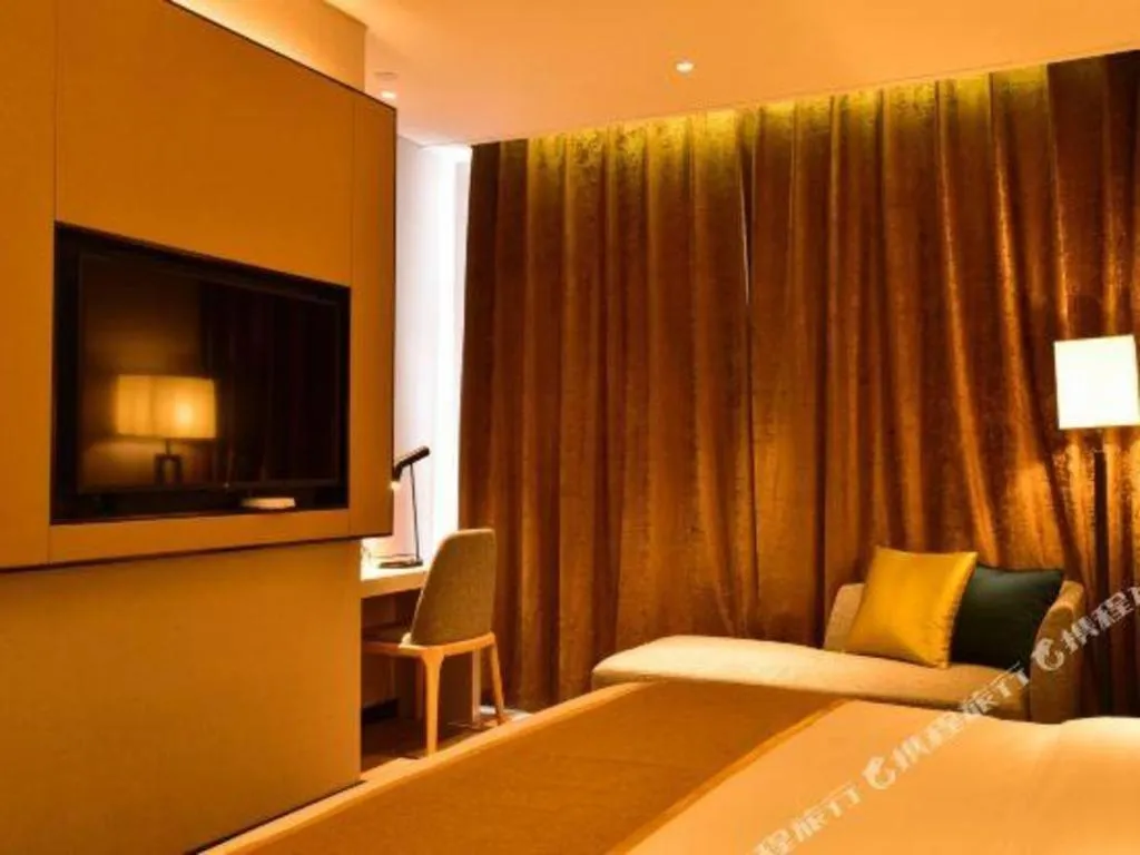 Bed in Echarm Hotel Xiantao Yuantai Weilaicheng