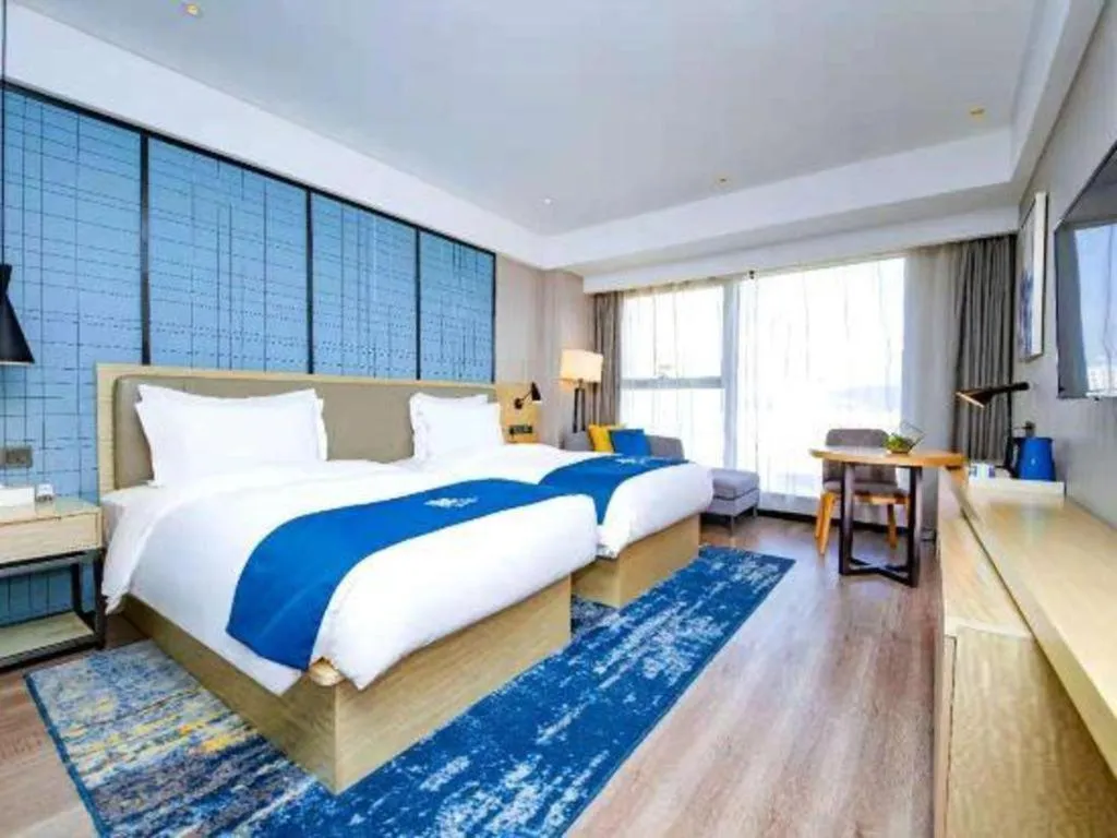 Bed in Echarm Hotel Xiantao Yuantai Weilaicheng