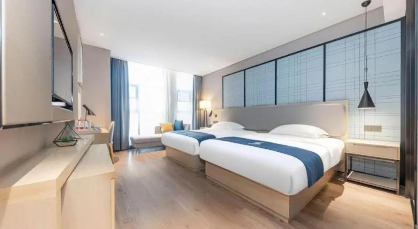 Bed in Echarm Hotel Xiantao Yuantai Weilaicheng